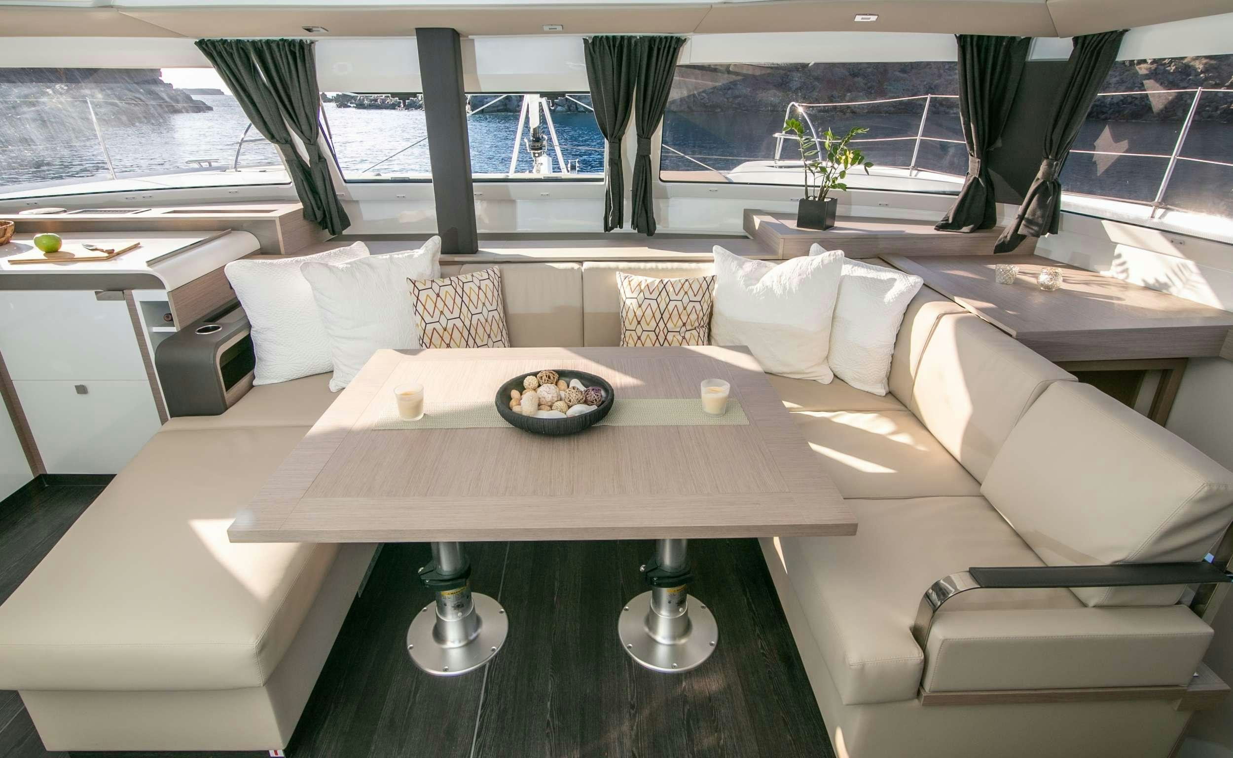 a living room with a couch and a table aboard PAROS Yacht for Charter