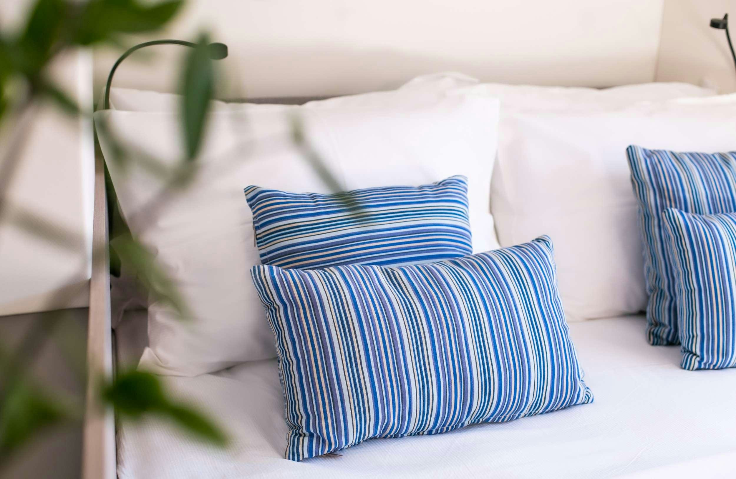 a bed with pillows aboard PAROS Yacht for Charter