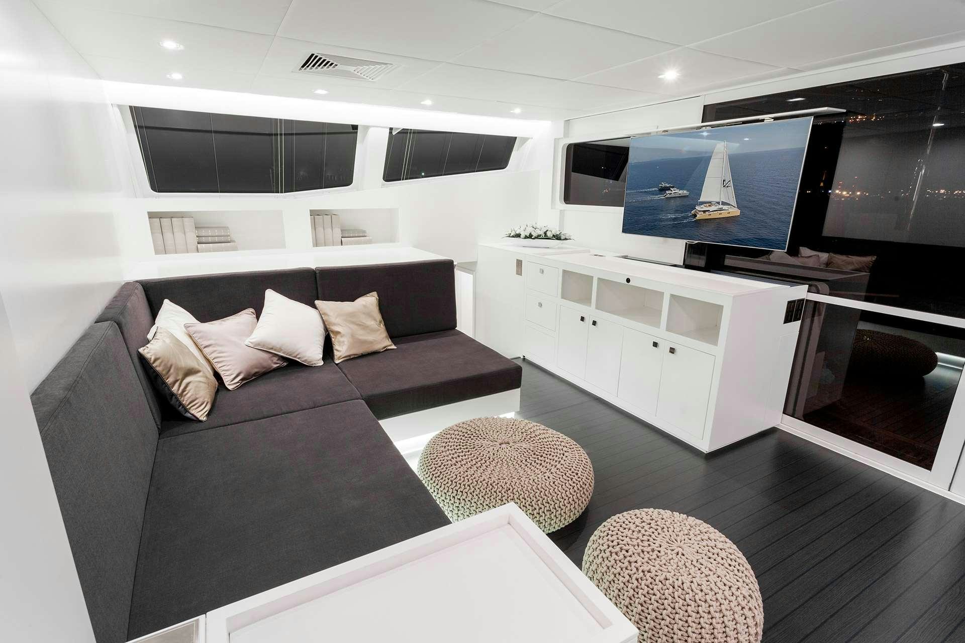 a living room with a couch and a tv aboard LEVANTE Yacht for Charter
