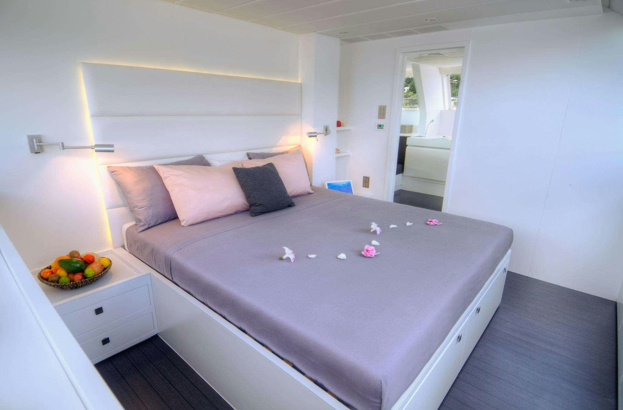 a bed with a tray of food aboard LEVANTE Yacht for Charter