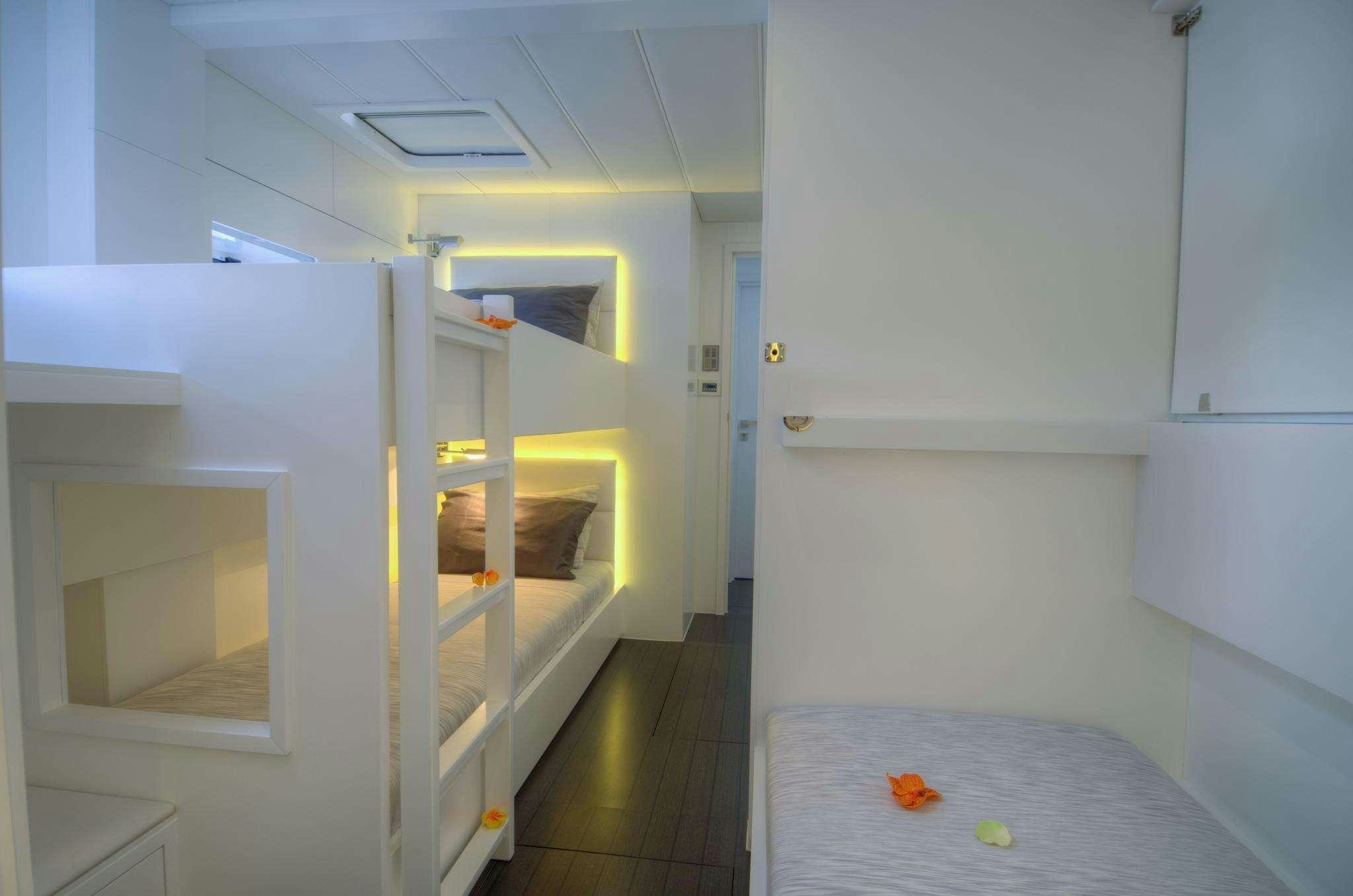 a room with a bed and a desk aboard LEVANTE Yacht for Charter