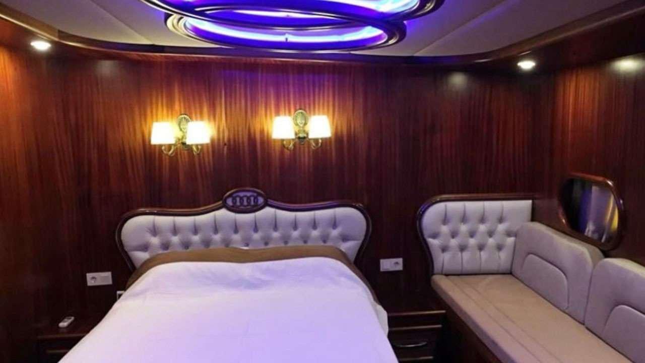 a room with a bed and a mirror aboard M/S E.ARDA DENIZ Yacht for Charter