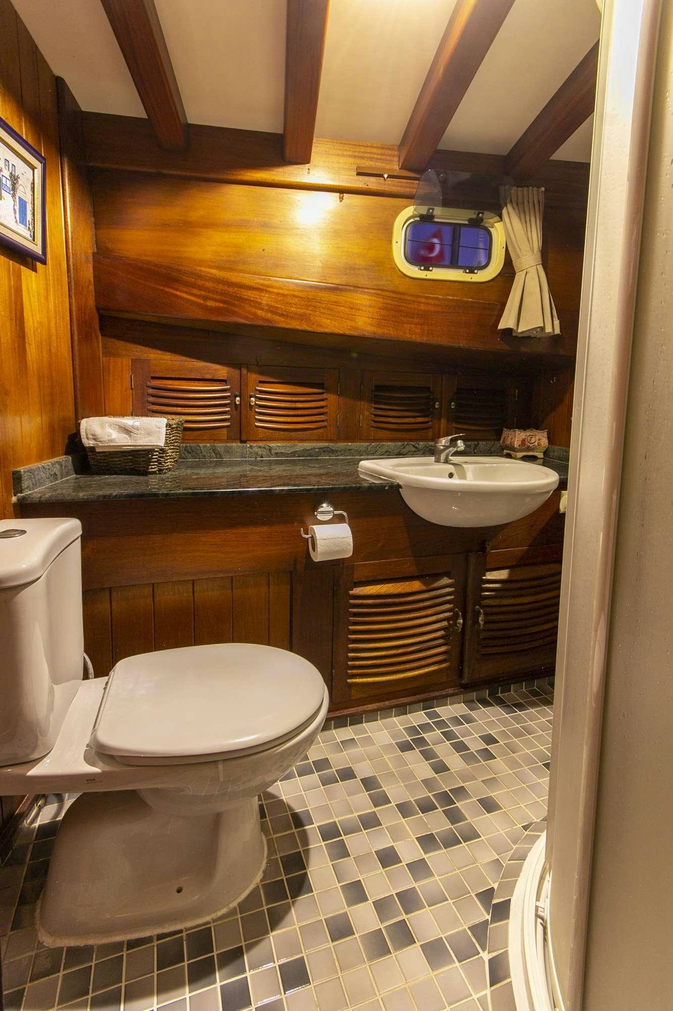 a bathroom with a sink and a toilet aboard SERENAD Yacht for Charter