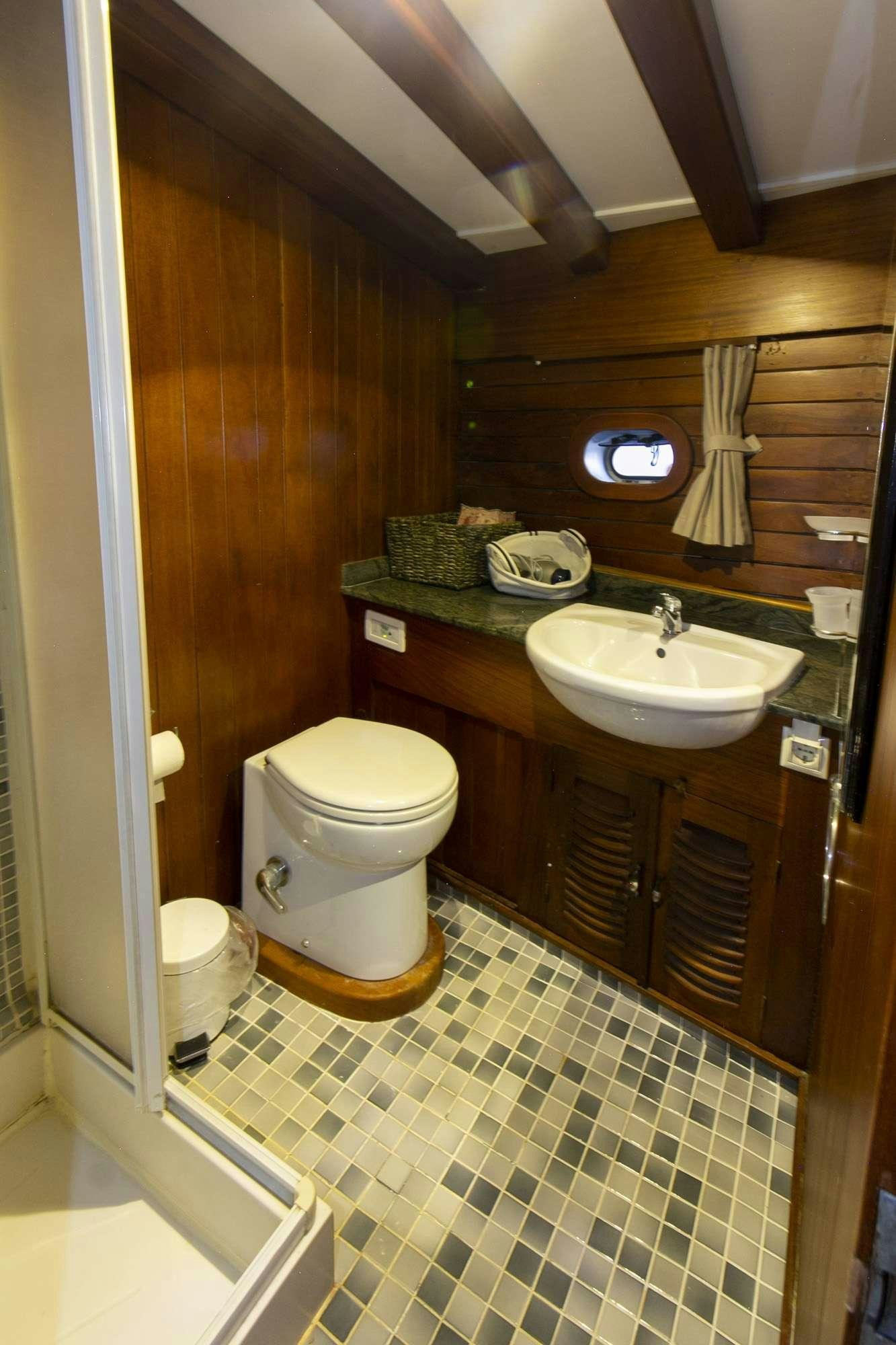 a bathroom with a toilet and sink aboard SERENAD Yacht for Charter