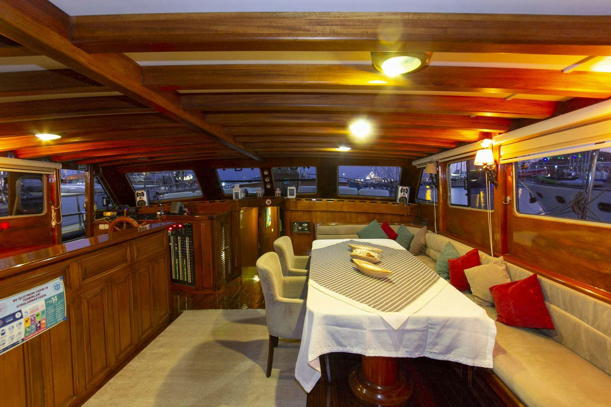 a train car with a table and chairs aboard SERENAD Yacht for Charter