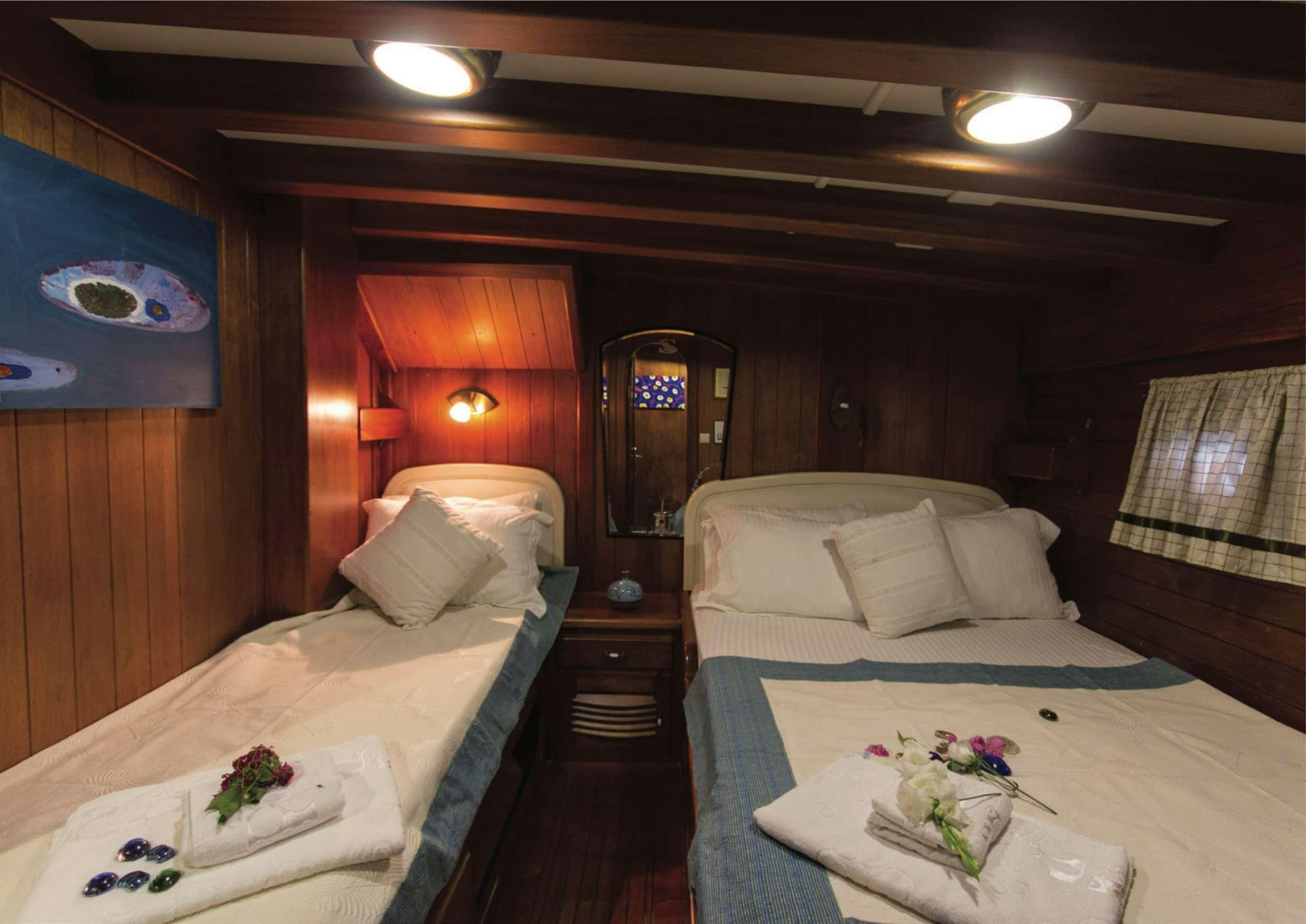 a room with two beds aboard SERENAD Yacht for Charter