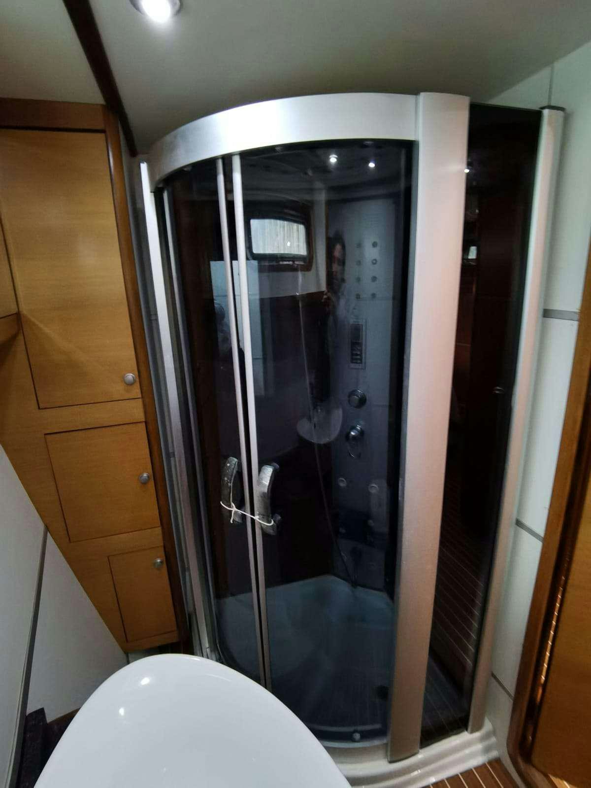 a shower unit with a glass door aboard BELLA Yacht for Charter