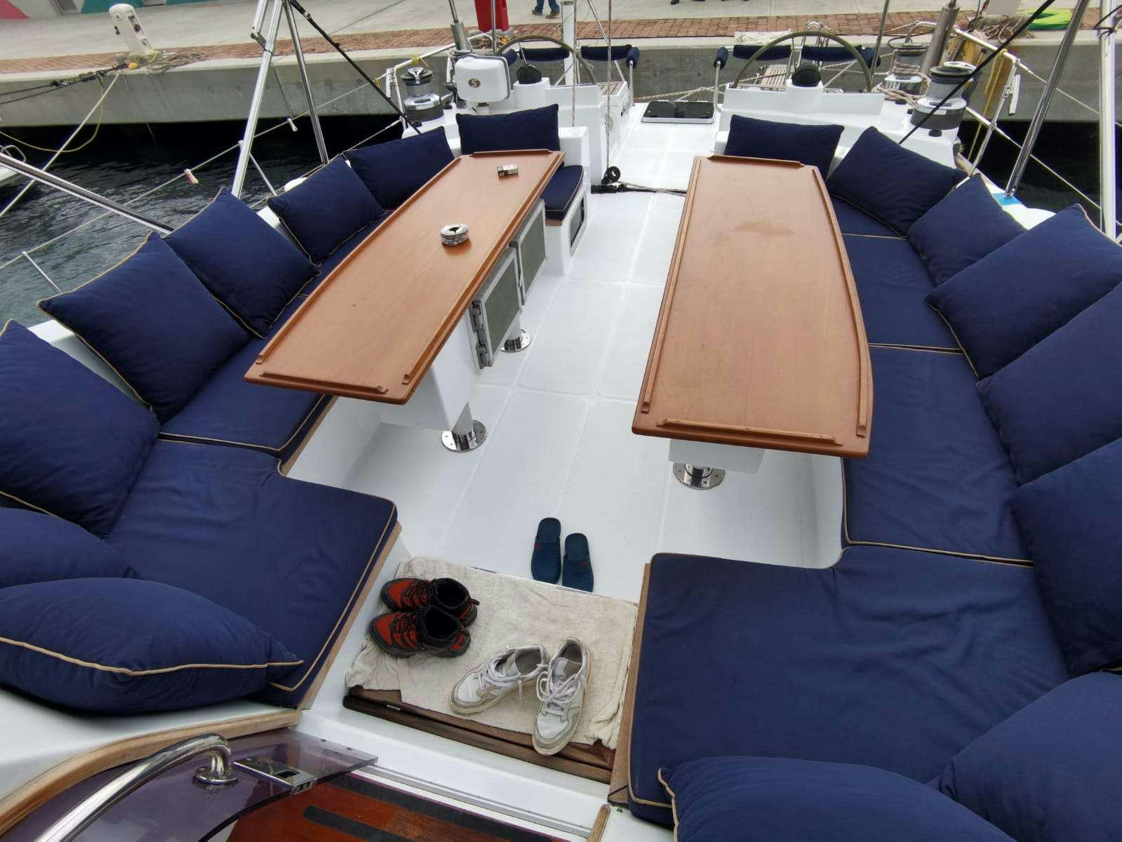 a boat with a table and chairs aboard BELLA Yacht for Charter