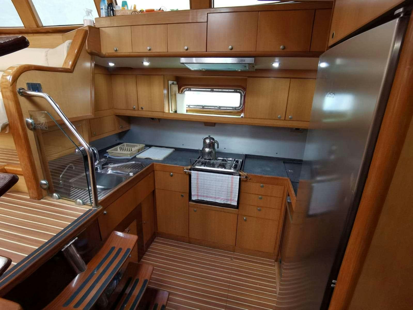 a kitchen with wooden cabinets aboard BELLA Yacht for Charter