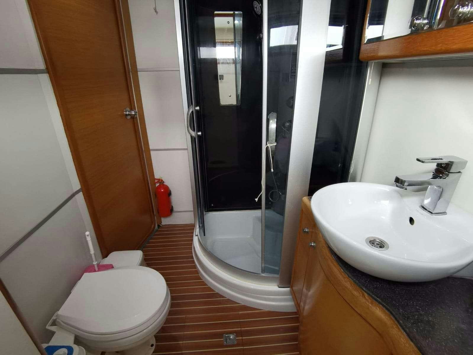 a bathroom with a shower and sink aboard BELLA Yacht for Charter