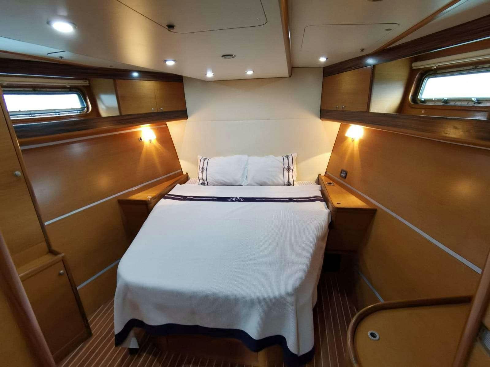 a room with a bed and a window aboard BELLA Yacht for Charter
