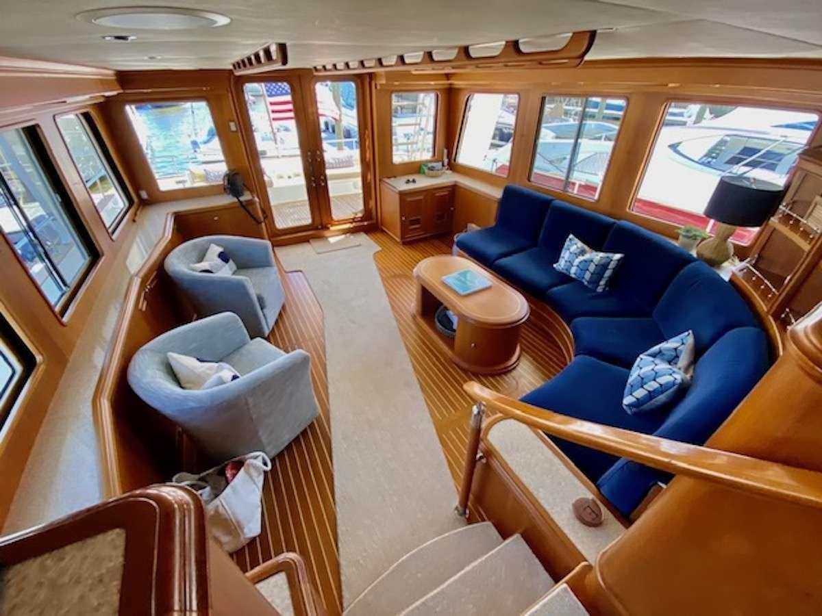 a train with a couch and chairs aboard ELLEON Yacht for Charter
