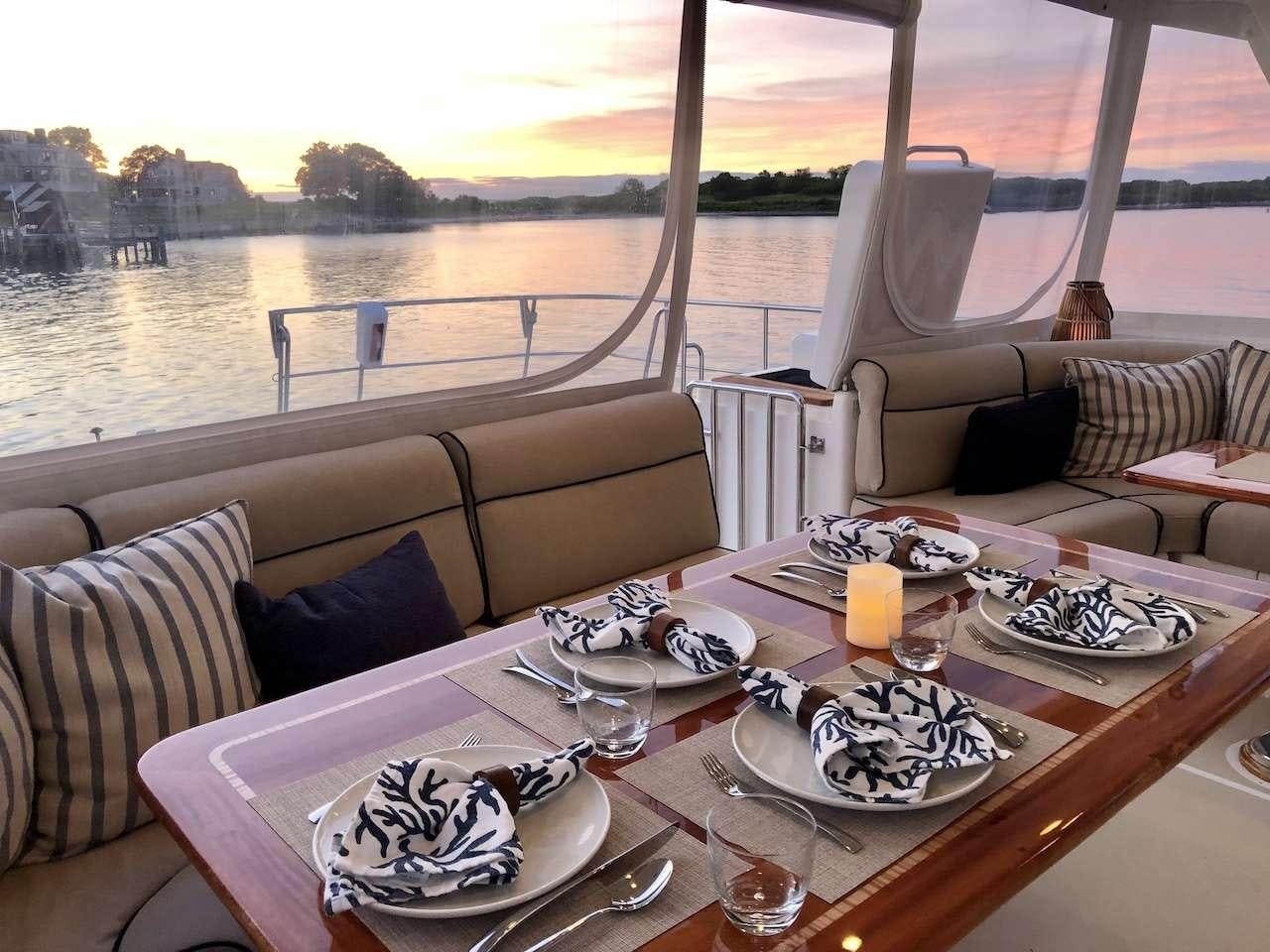 a table with plates and food on it aboard ELLEON Yacht for Charter