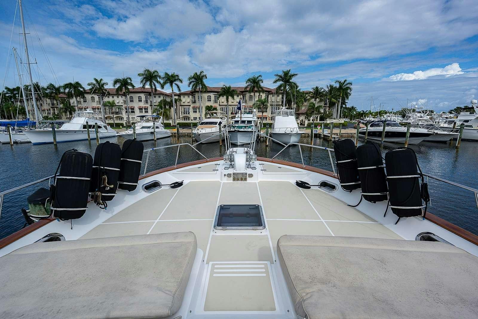 a group of chairs on a deck overlooking a beach aboard ELLEON Yacht for Charter