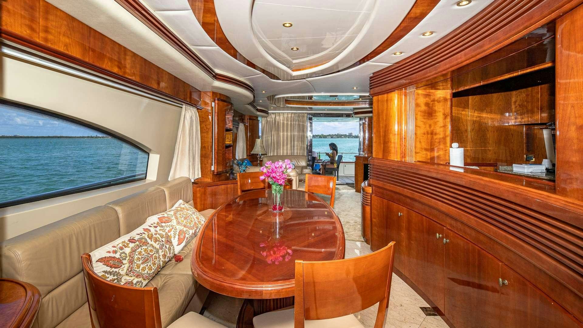 a room with a table and chairs aboard grace Yacht for Charter