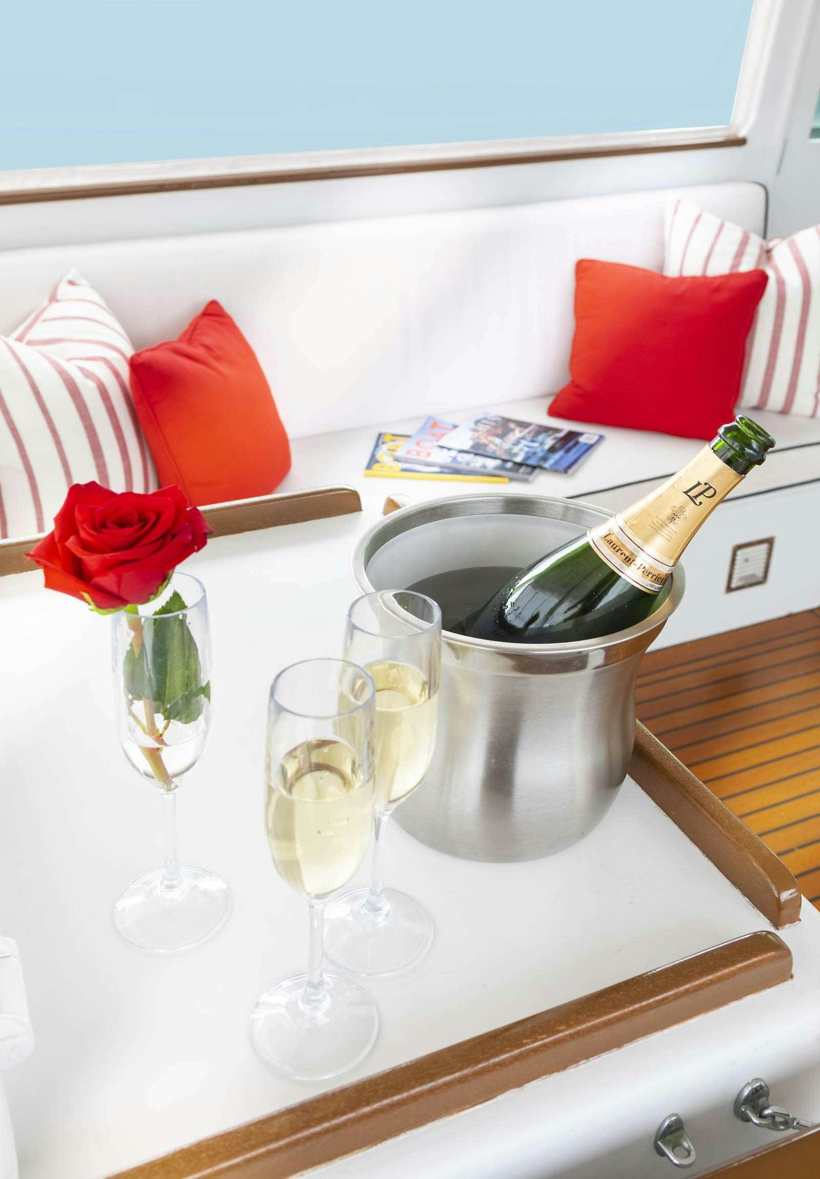 a wine glass and wine bottle on a shelf aboard SEA BOUND Yacht for Charter