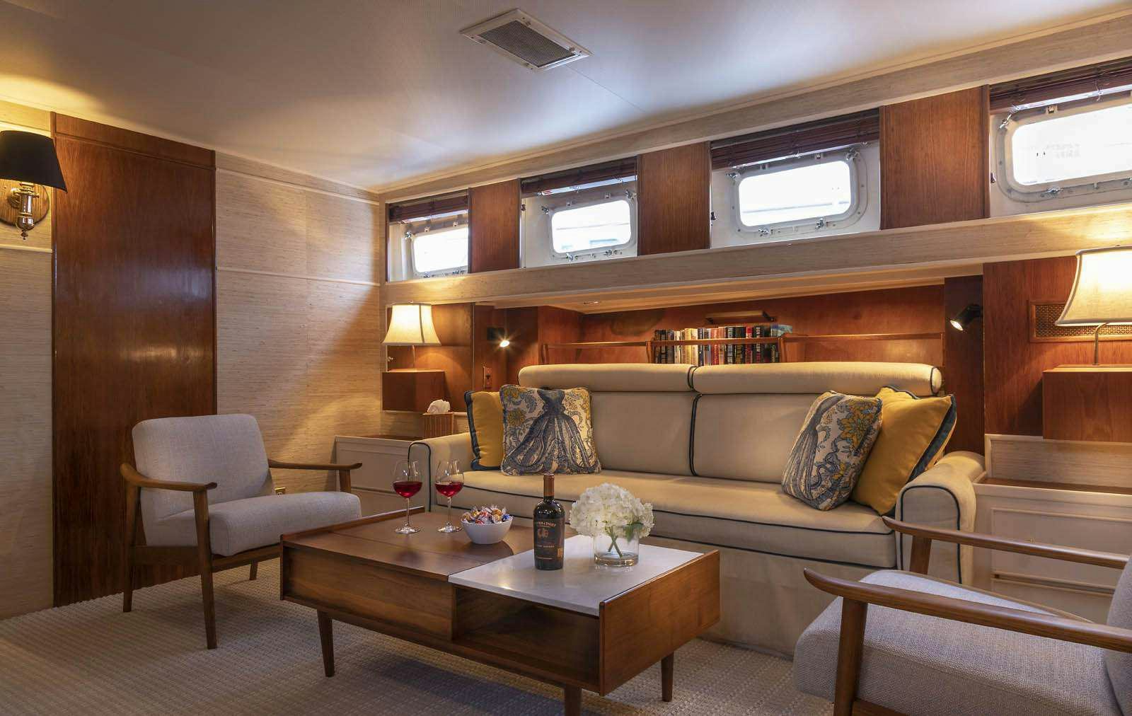 a living room with a couch and a coffee table aboard SEA BOUND Yacht for Charter
