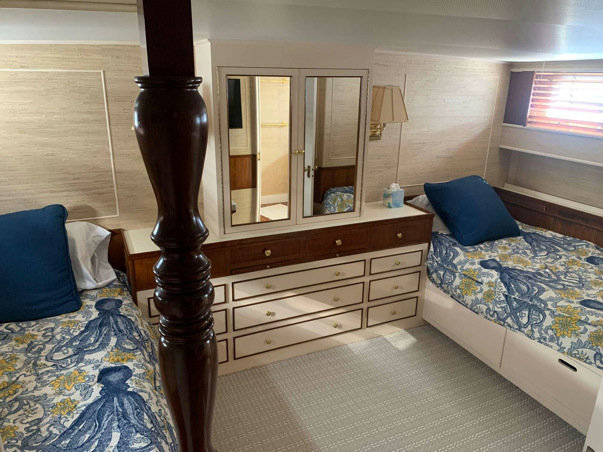 a bedroom with a bed and a mirror aboard SEA BOUND Yacht for Charter