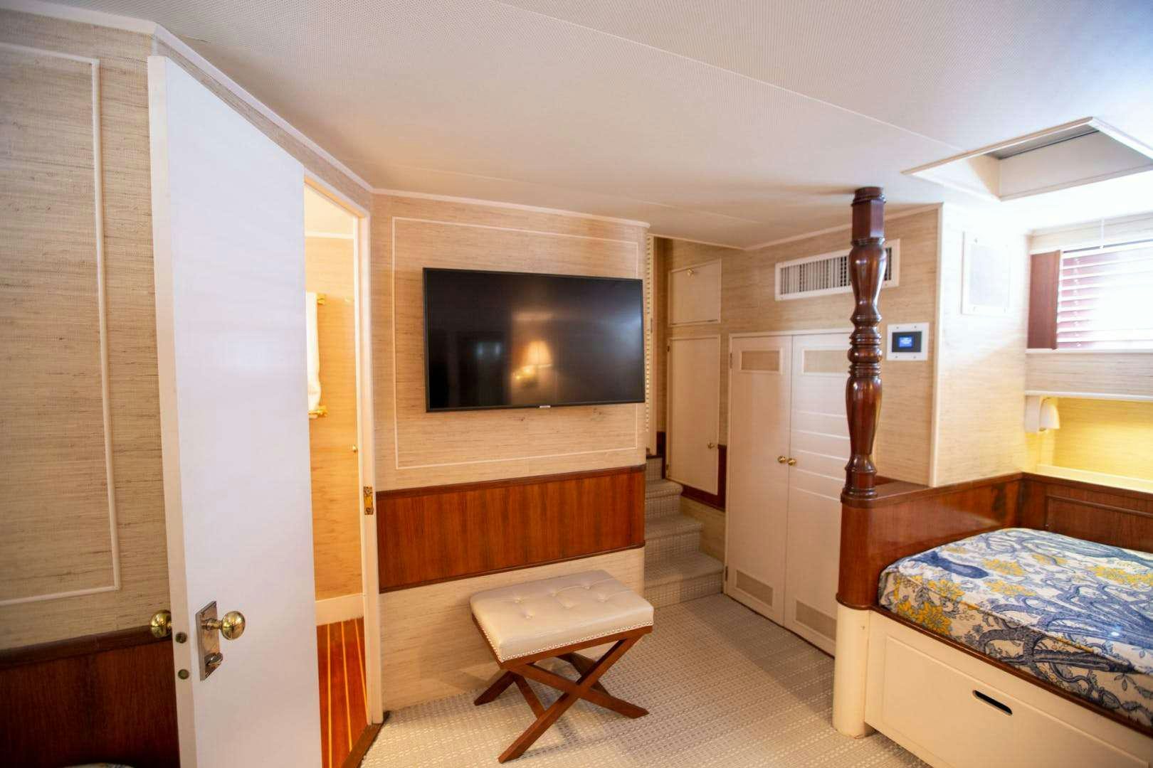 a room with a fireplace and a television aboard SEA BOUND Yacht for Charter