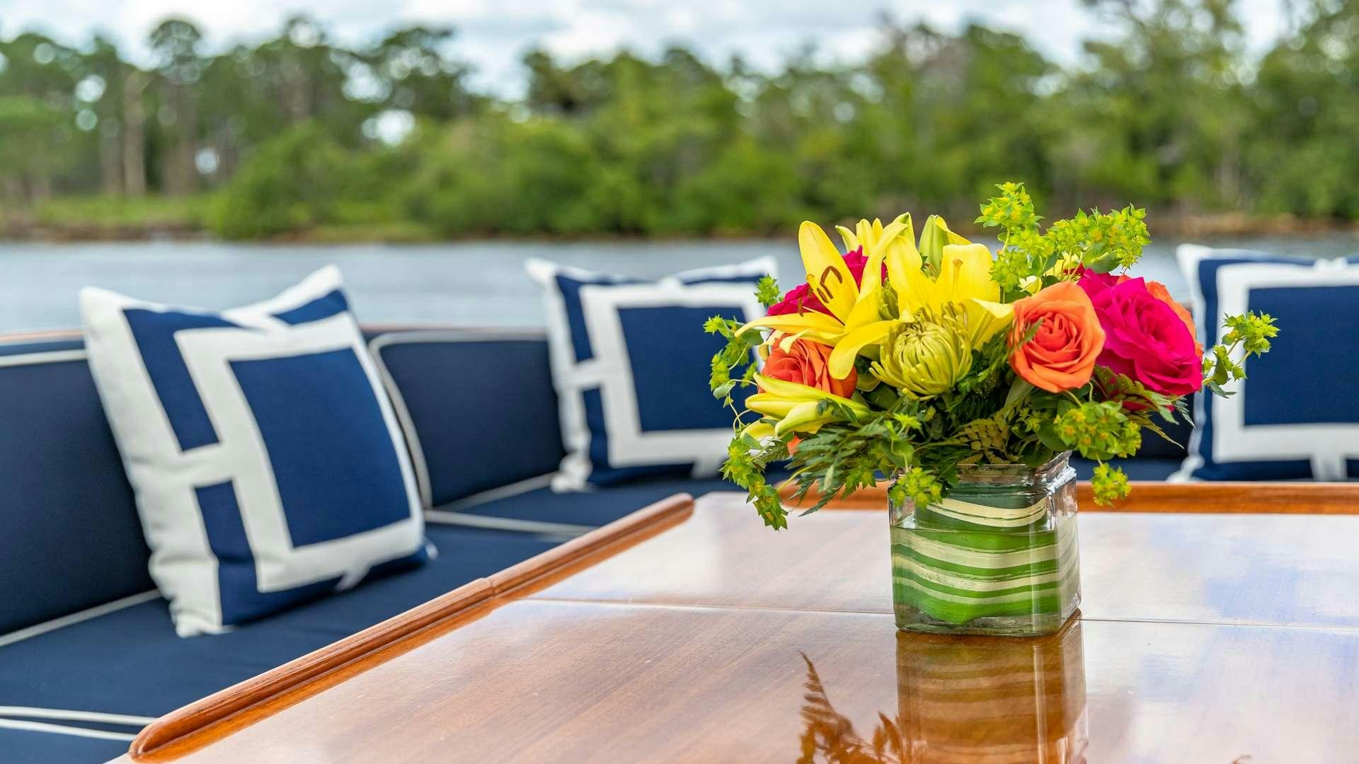 a vase of flowers on a table aboard FALCON Yacht for Charter