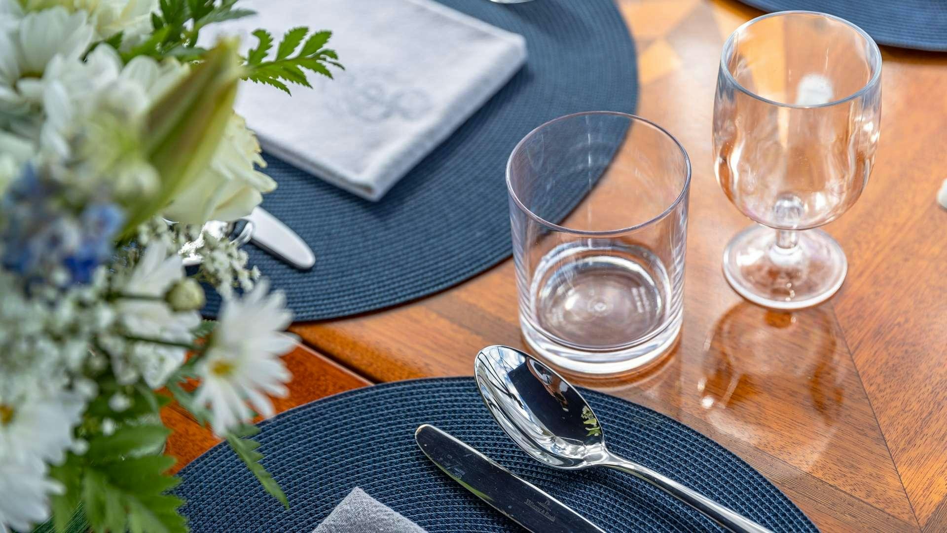 a glass of wine on a table aboard FALCON Yacht for Charter