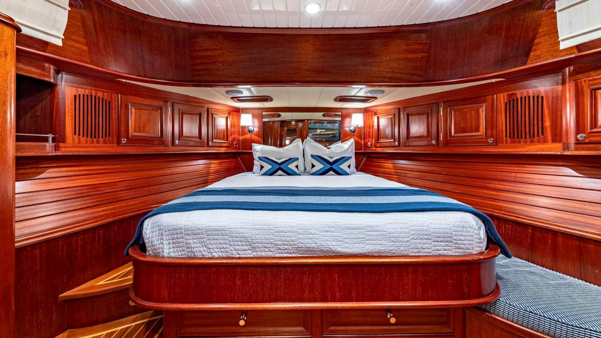 a bed in a wooden cabin aboard FALCON Yacht for Charter