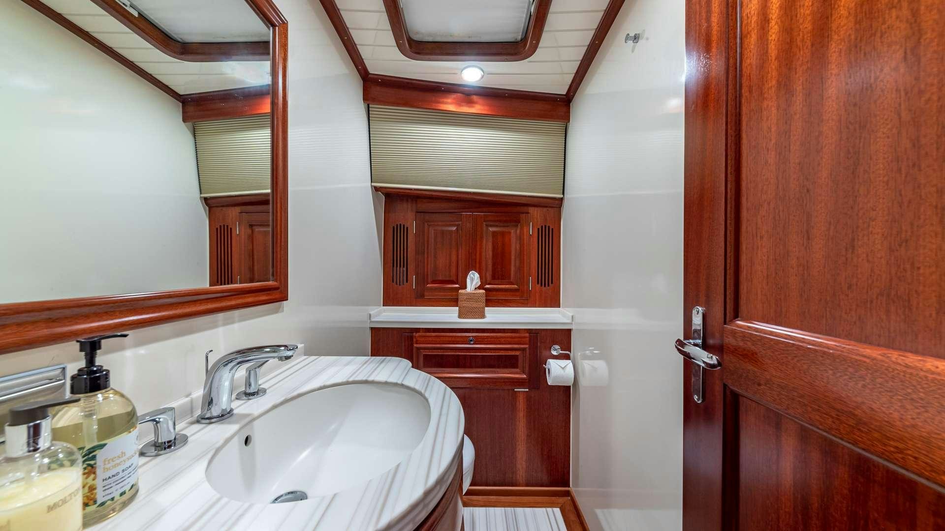a bathroom with a sink and cabinets aboard FALCON Yacht for Charter