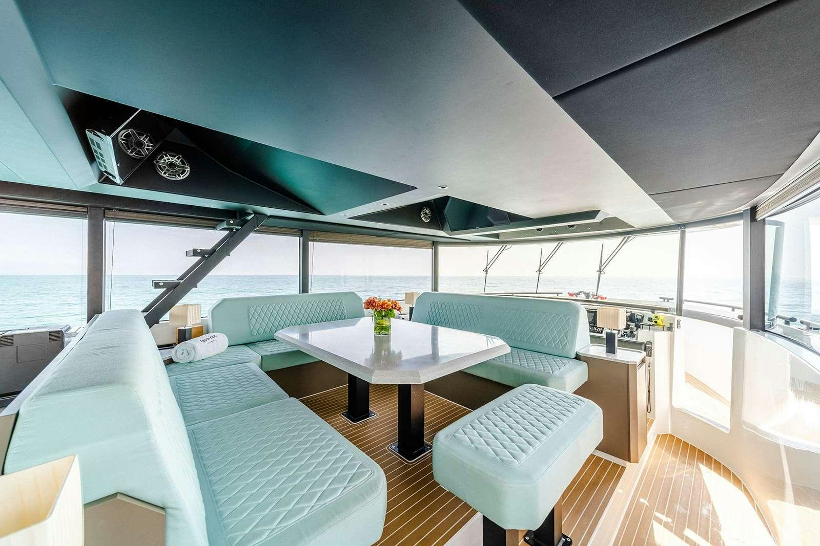 a room with a table and chairs aboard GO N HOT Yacht for Charter