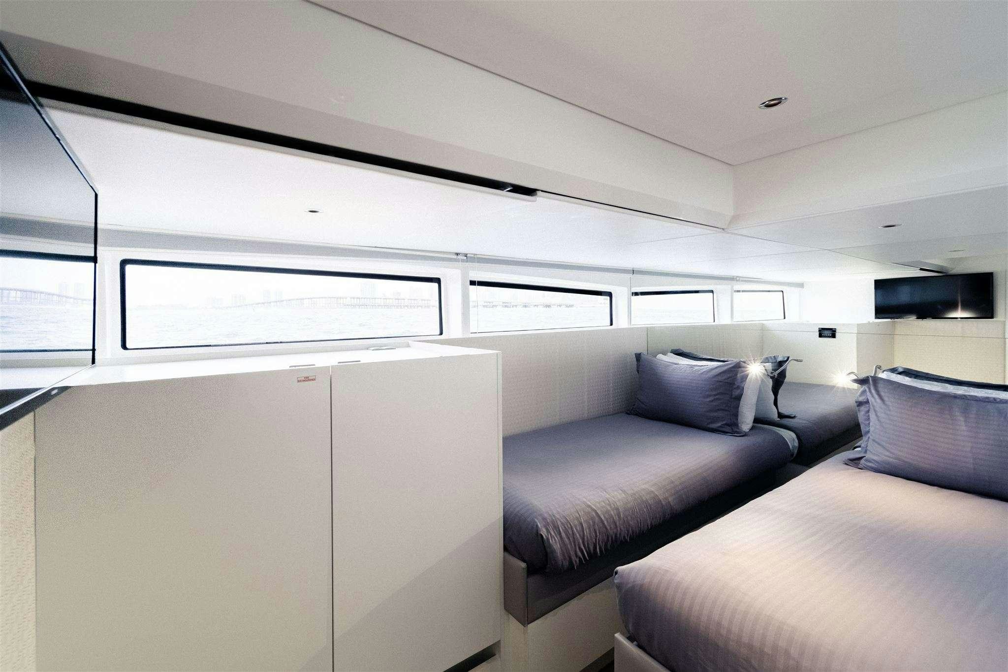 a room with a bed and a couch aboard GO N HOT Yacht for Charter