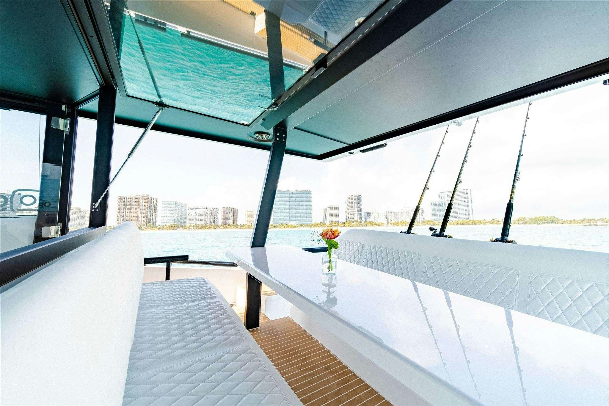 a room with a table and chairs aboard GO N HOT Yacht for Charter