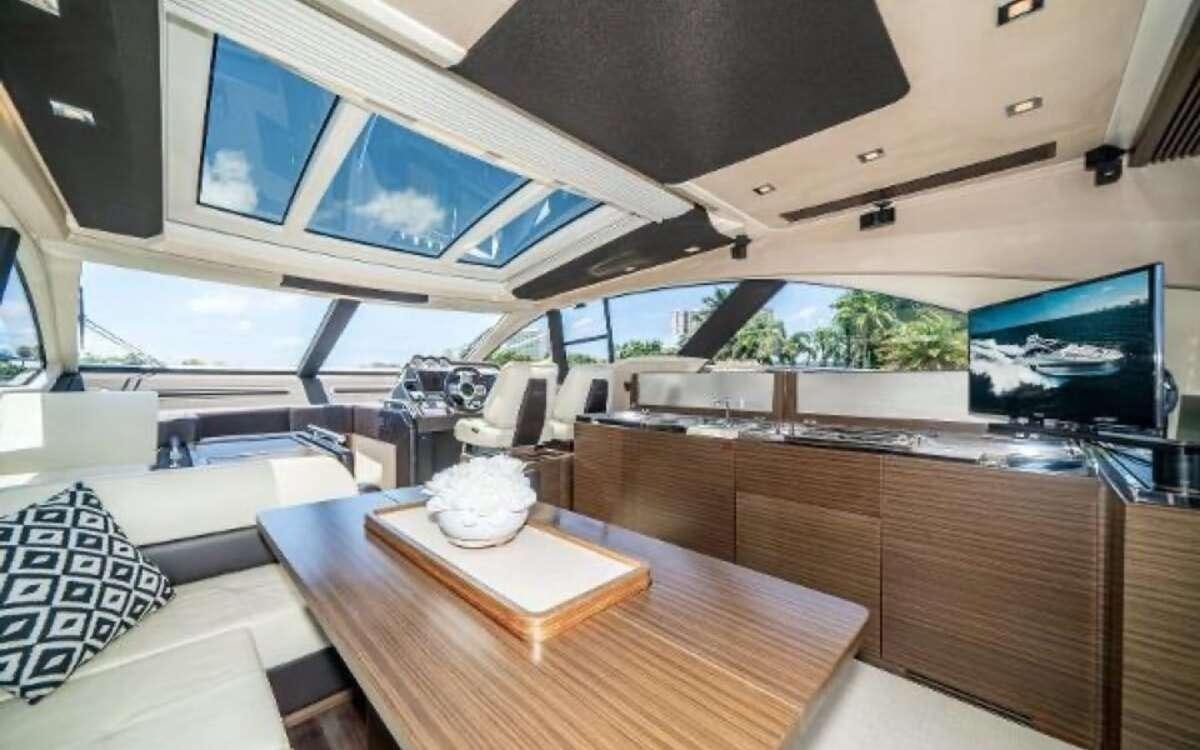 a room with a table and a tv aboard CORSAIR Yacht for Charter