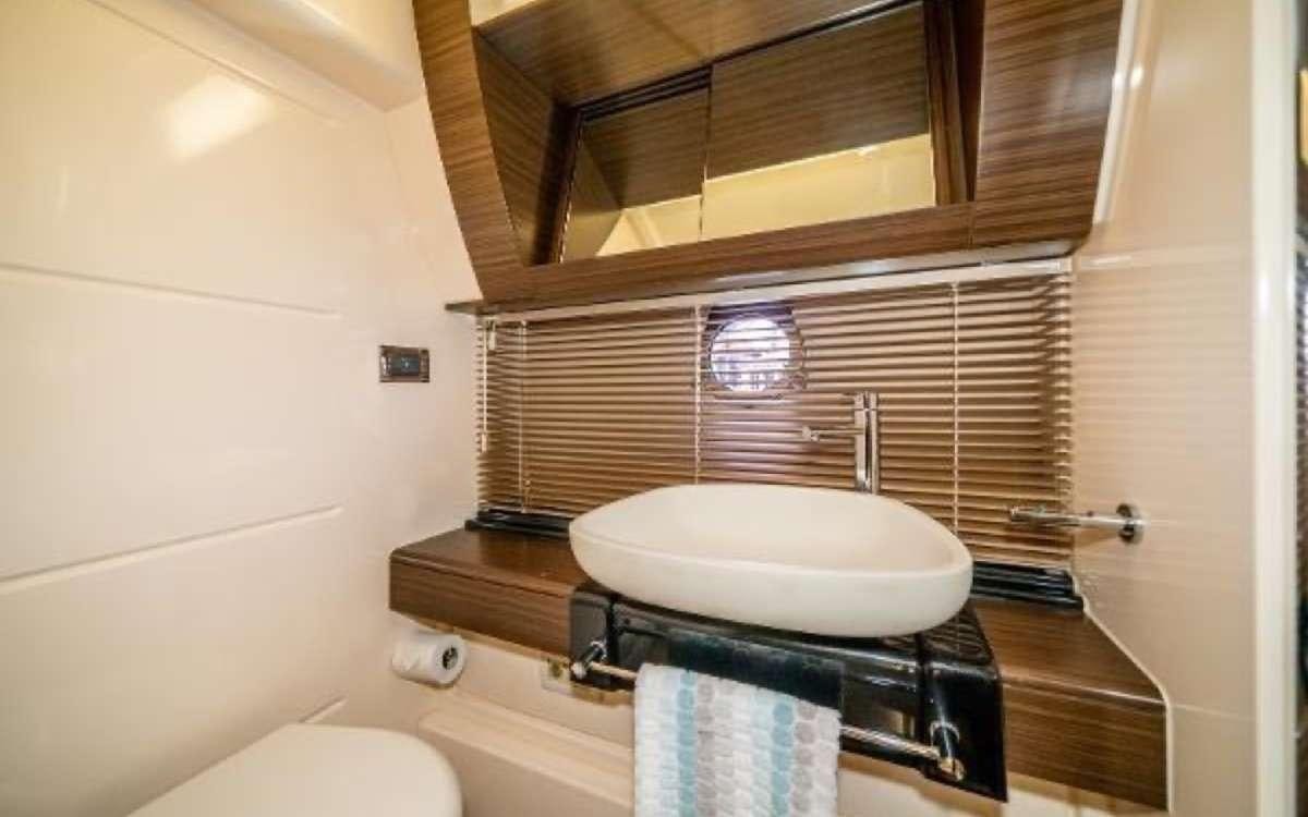 a bathroom with a sink and a mirror aboard CORSAIR Yacht for Charter