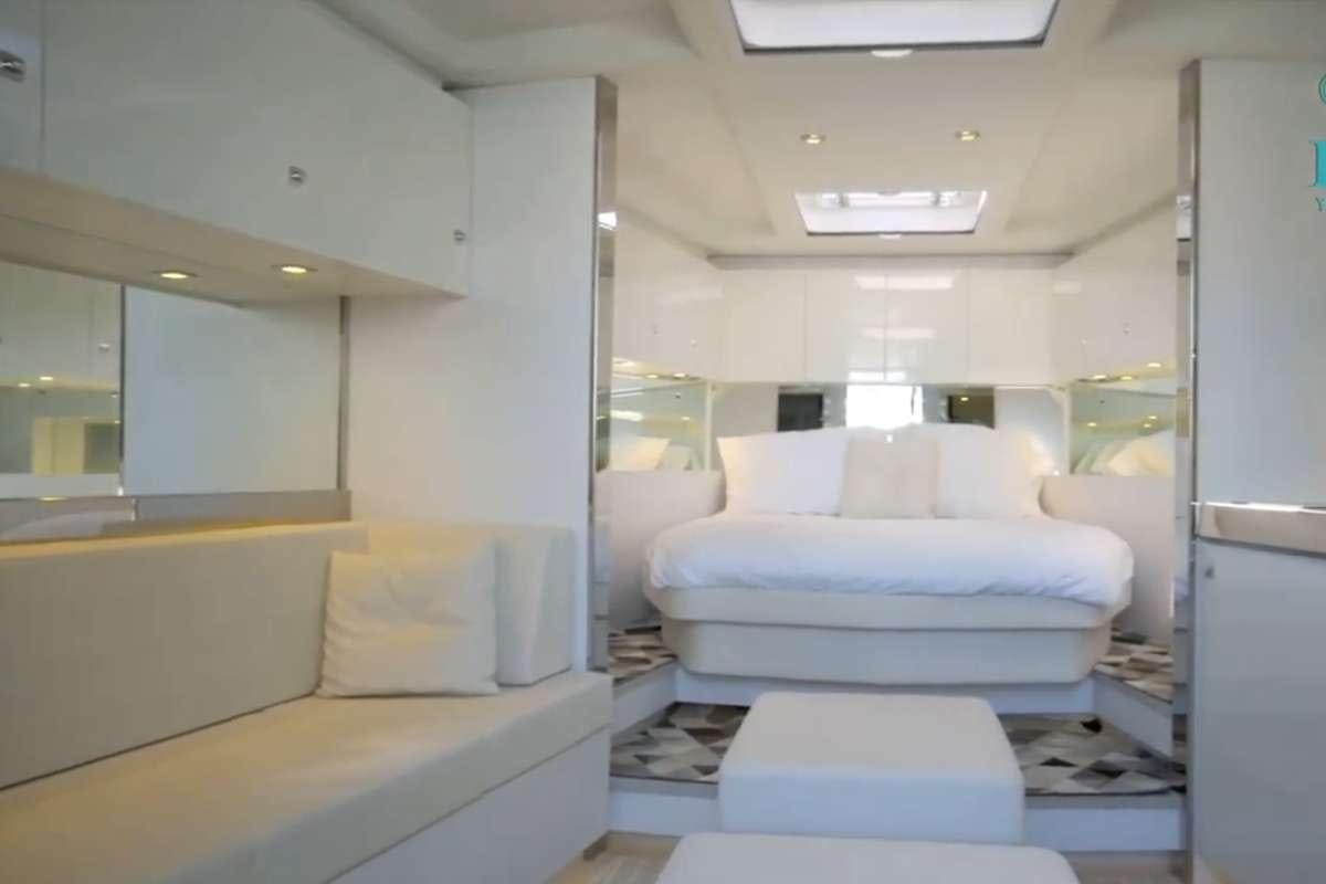 a room with a bed and a couch aboard BIG BANG Yacht for Charter
