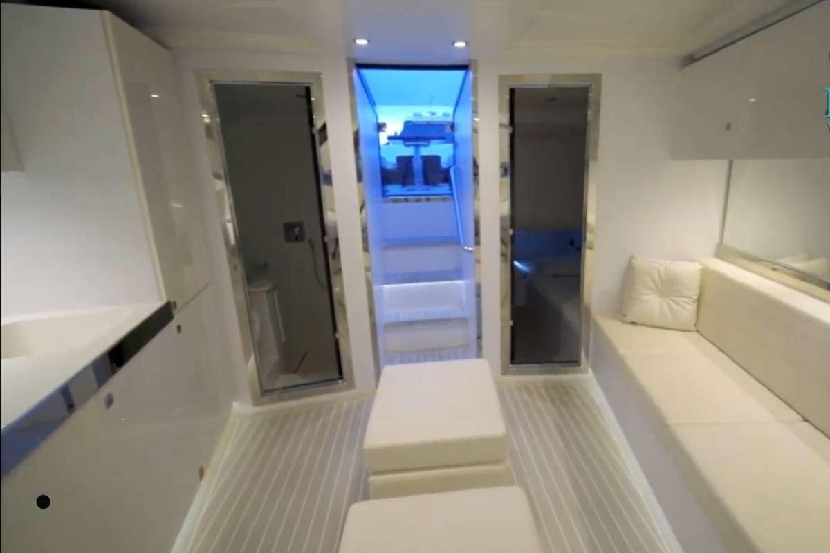 a room with a bed and a door aboard BIG BANG Yacht for Charter