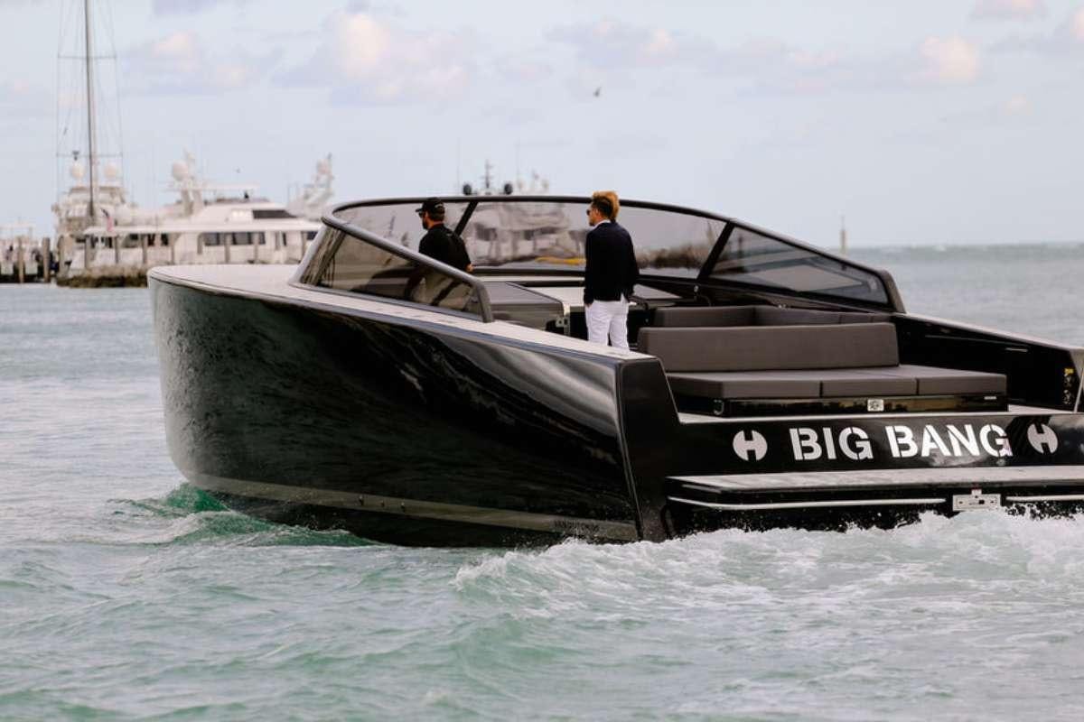 a couple of men standing on a boat in the water aboard BIG BANG Yacht for Charter