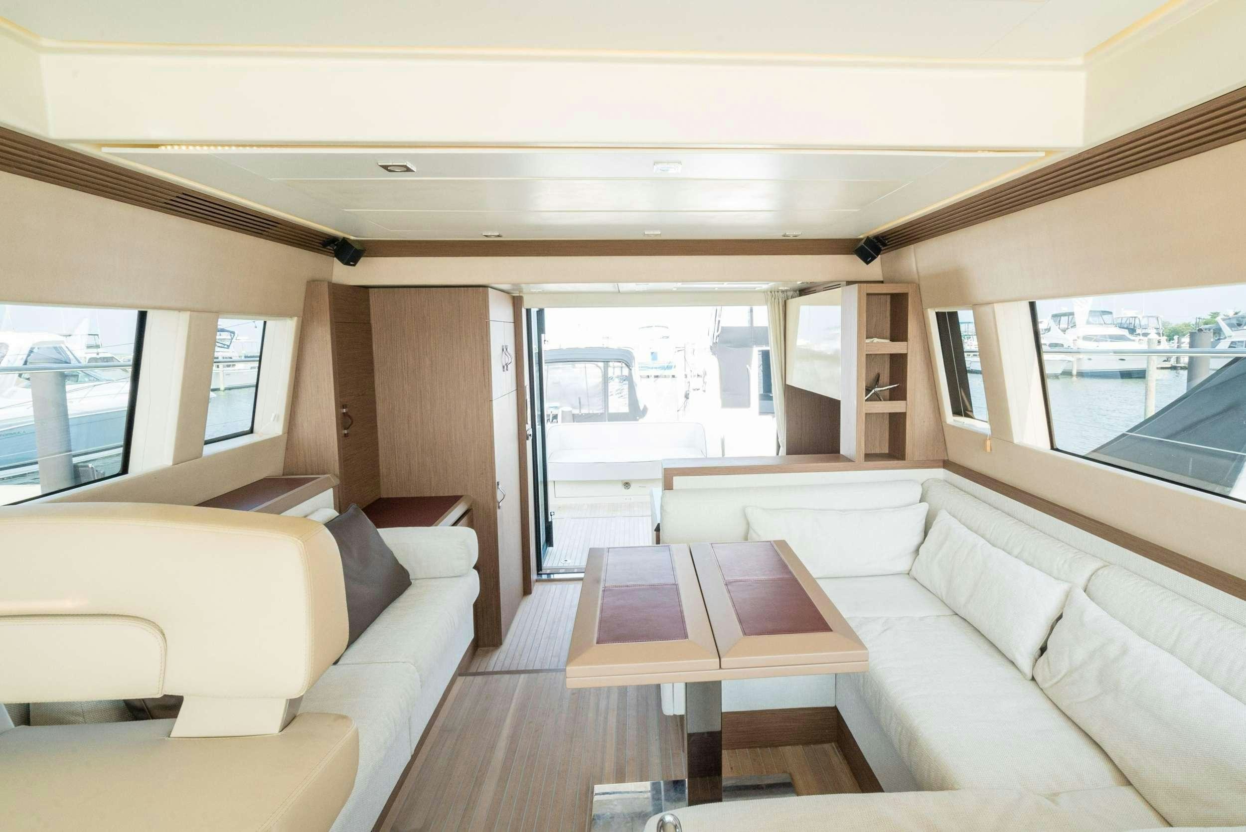 a living room with a large window aboard PILOTS LOUNGE Yacht for Charter