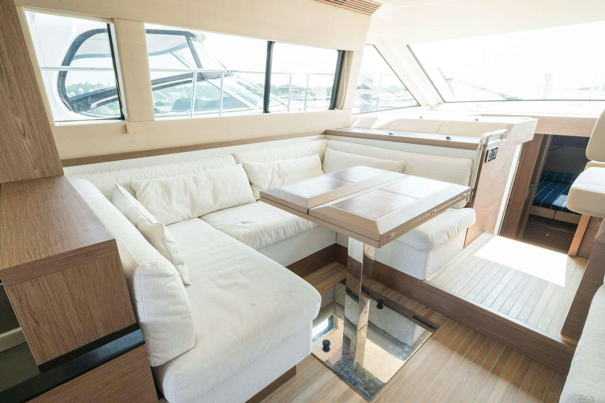 a room with a bed and a table aboard PILOTS LOUNGE Yacht for Charter