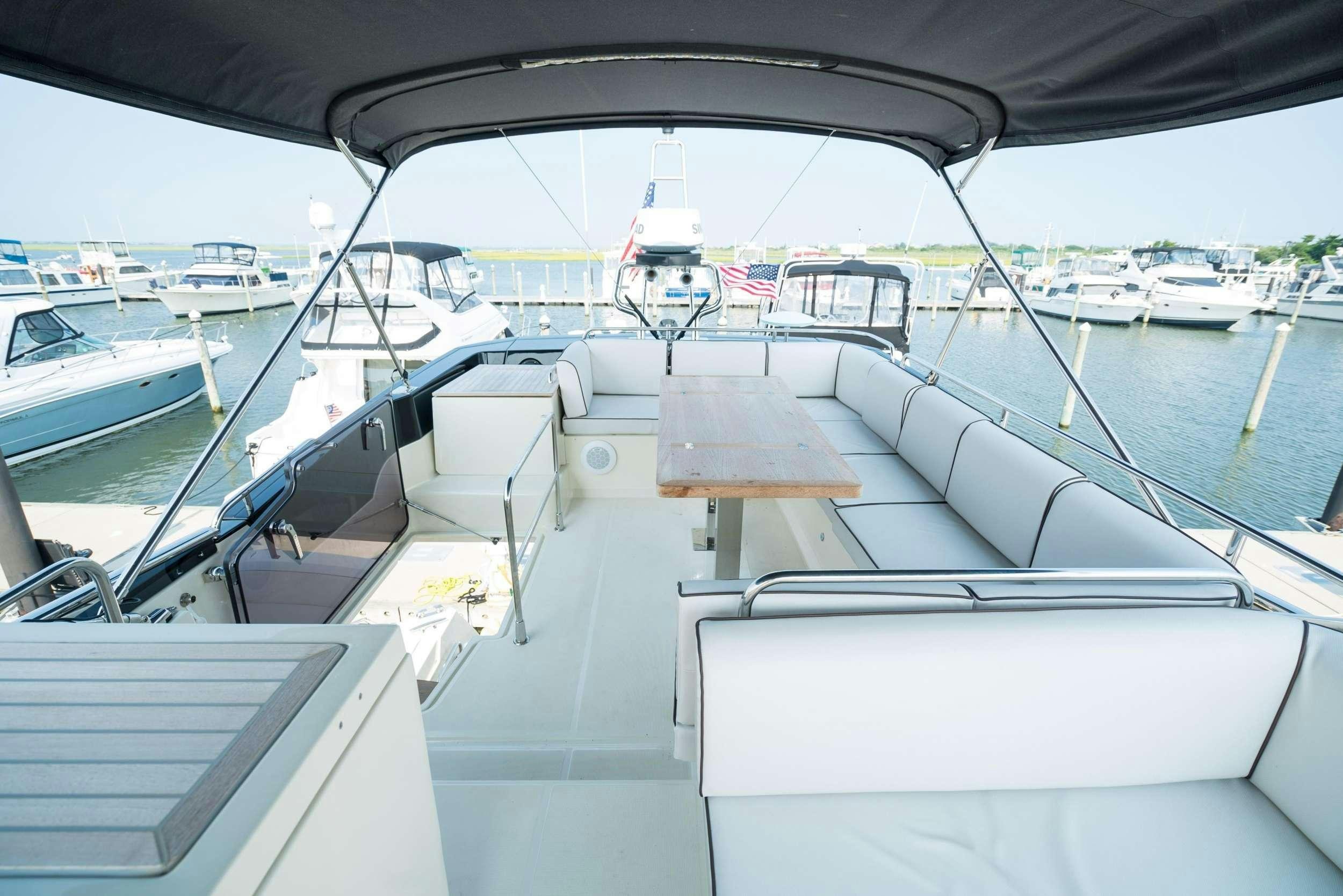 a boat with a bench on it aboard PILOTS LOUNGE Yacht for Charter