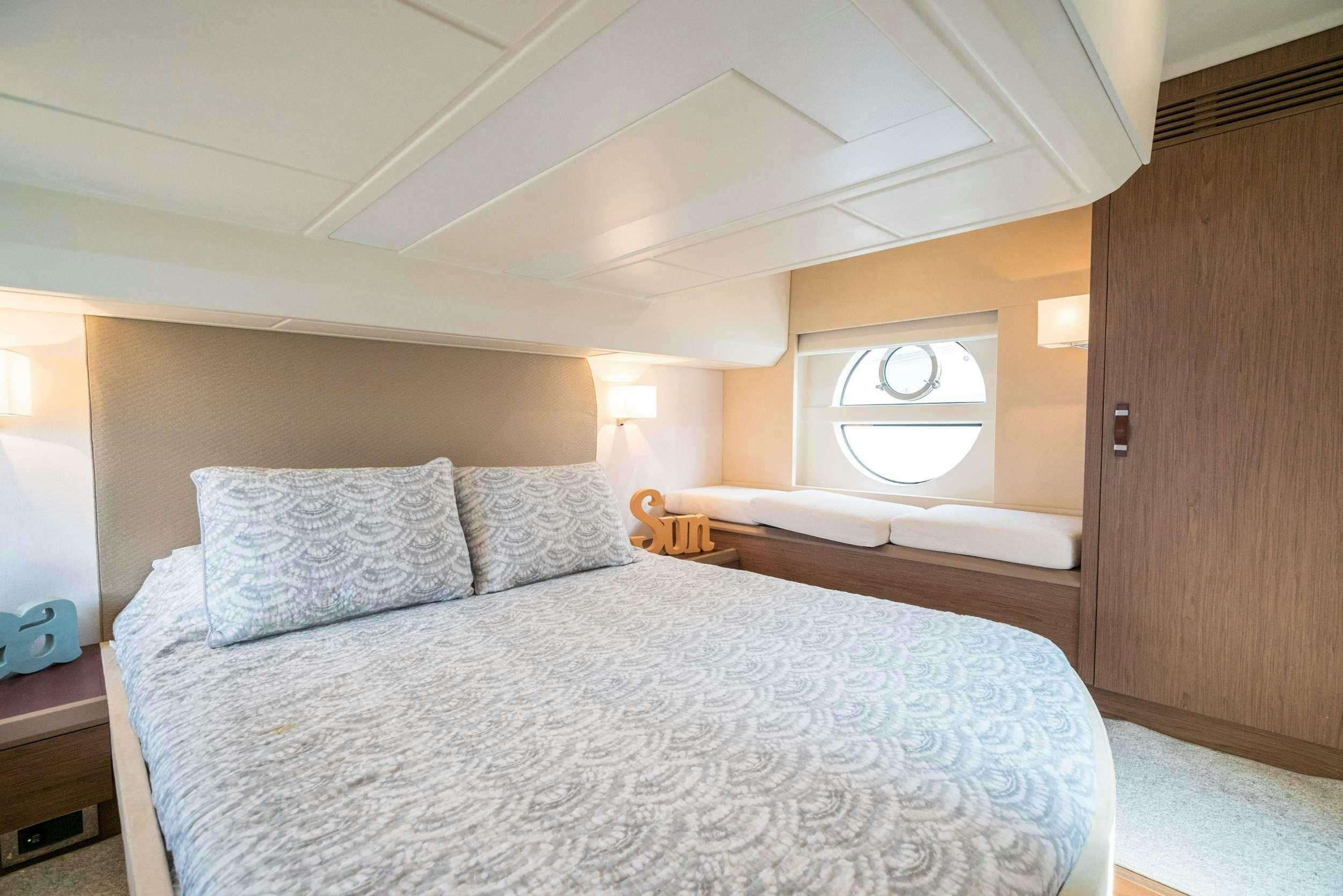 a bedroom with a bed and a wood door aboard PILOTS LOUNGE Yacht for Charter