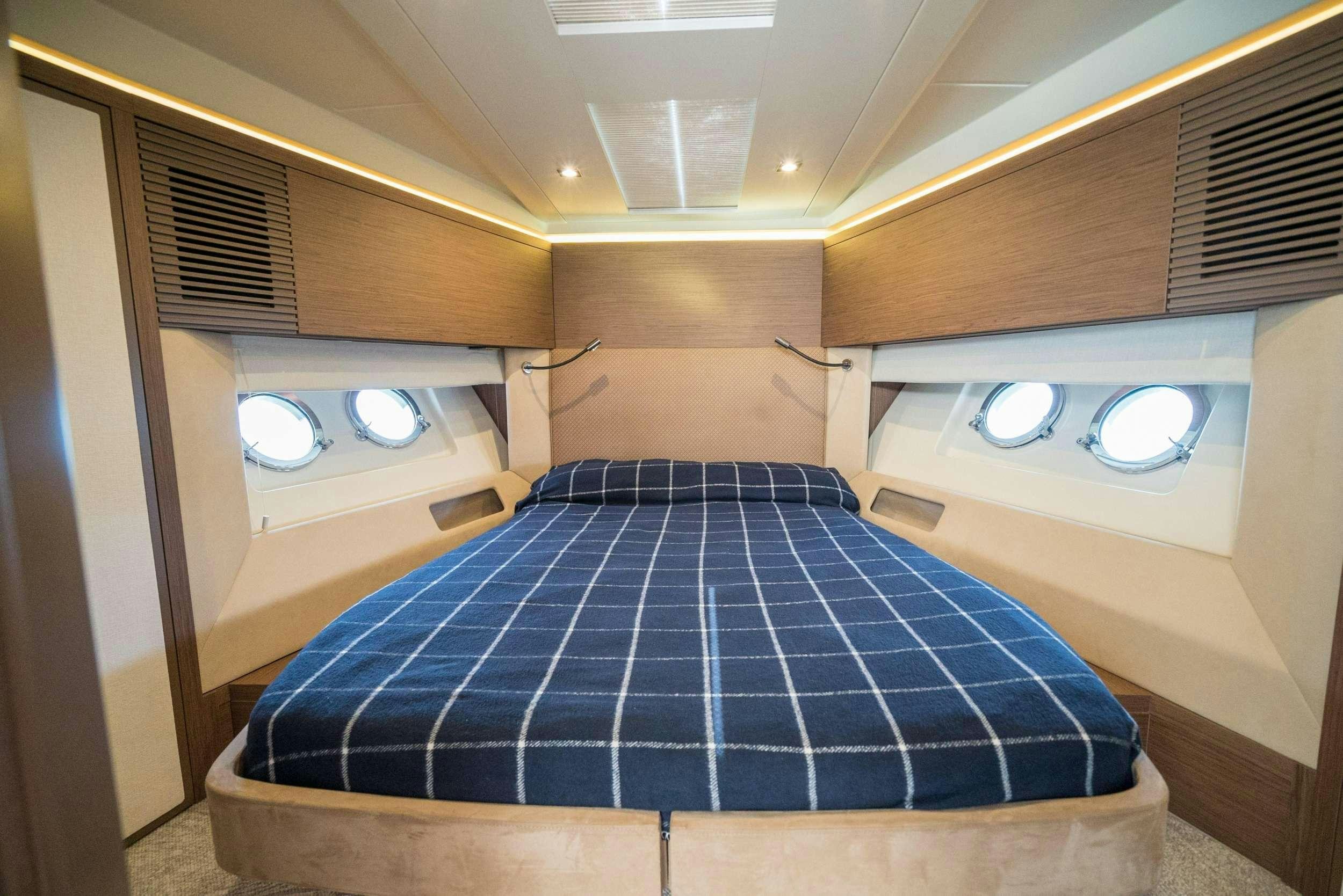 a room with a bed and a window aboard PILOTS LOUNGE Yacht for Charter