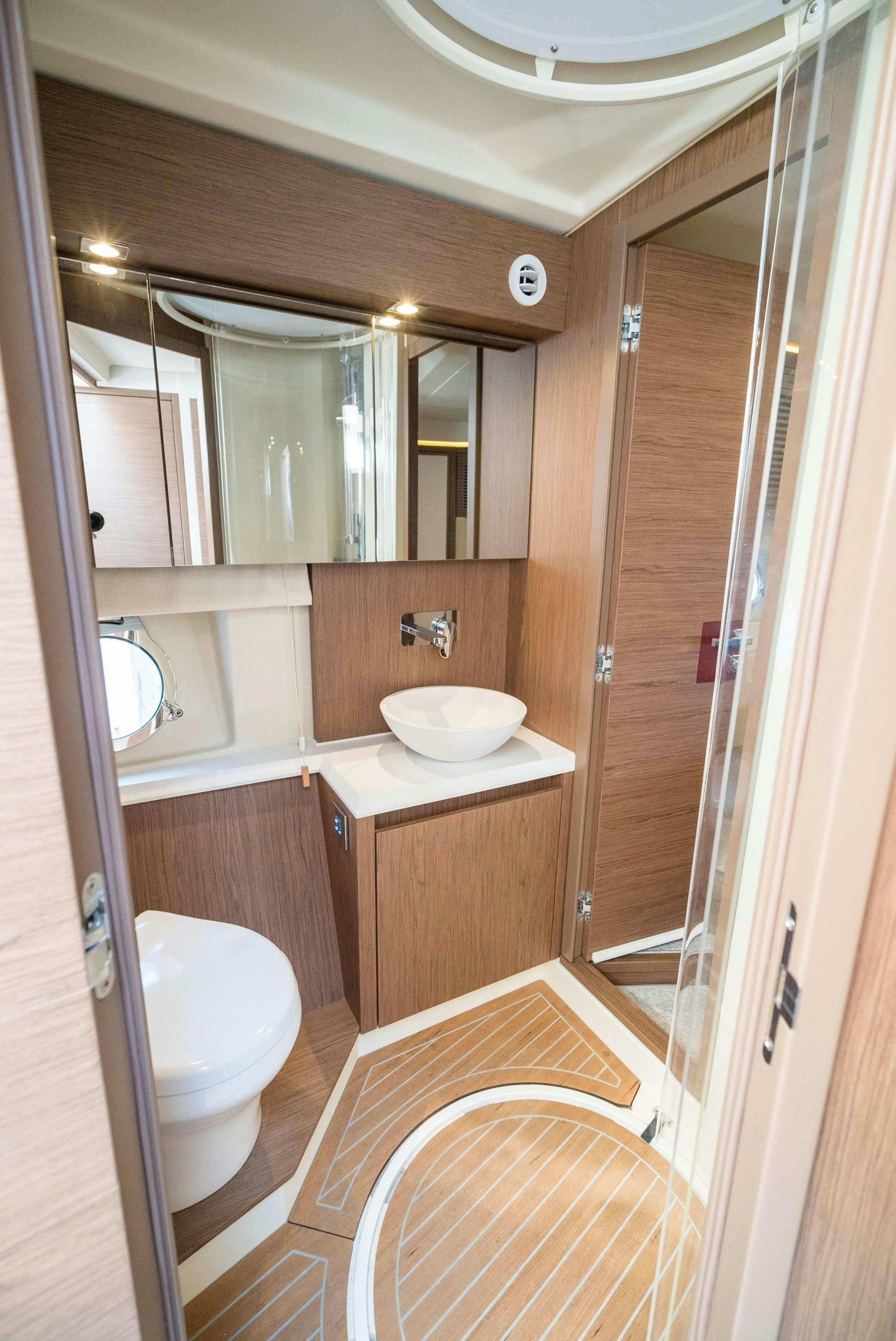 a bathroom with a toilet and a sink aboard PILOTS LOUNGE Yacht for Charter