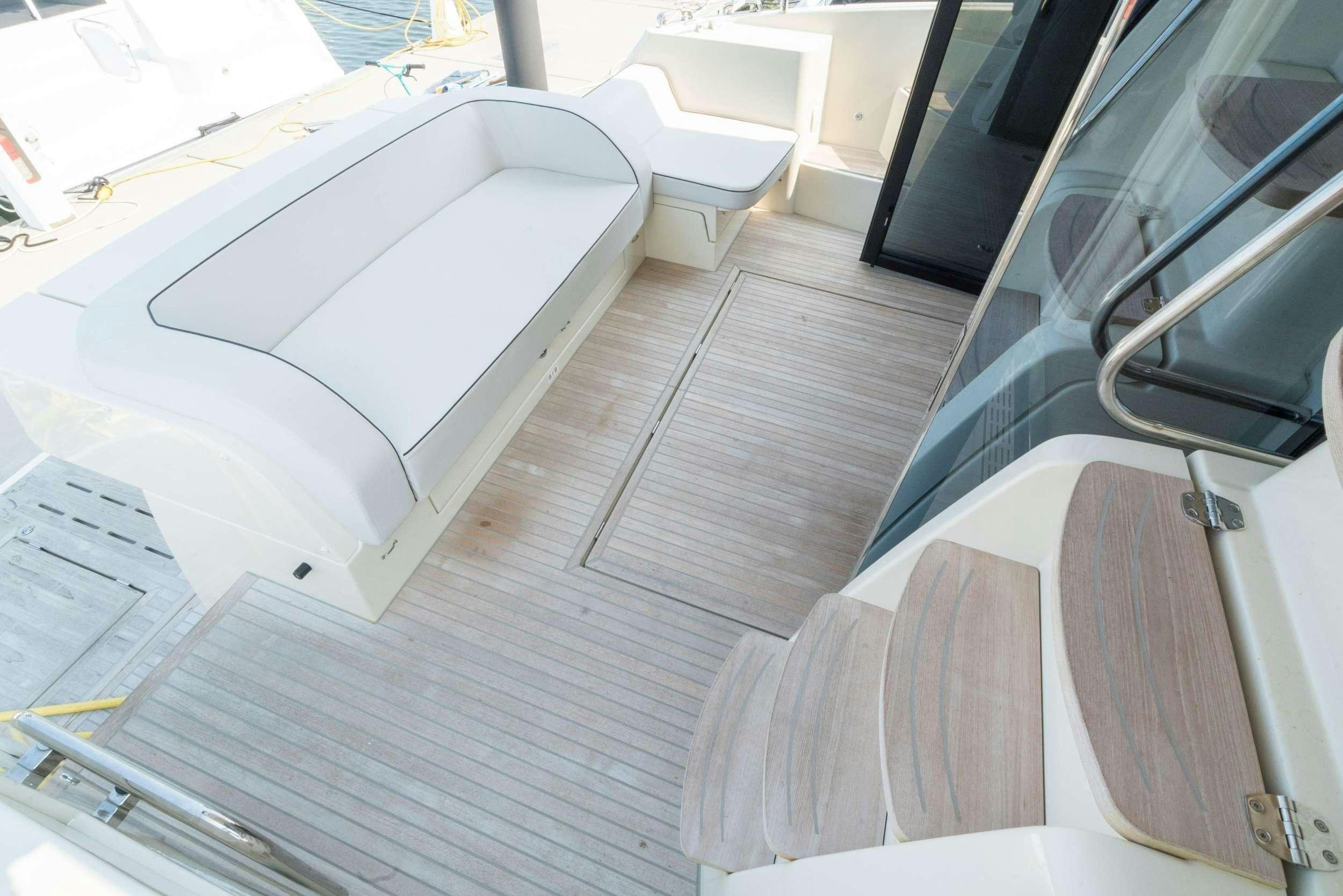 a white car on a wooden deck aboard PILOTS LOUNGE Yacht for Charter