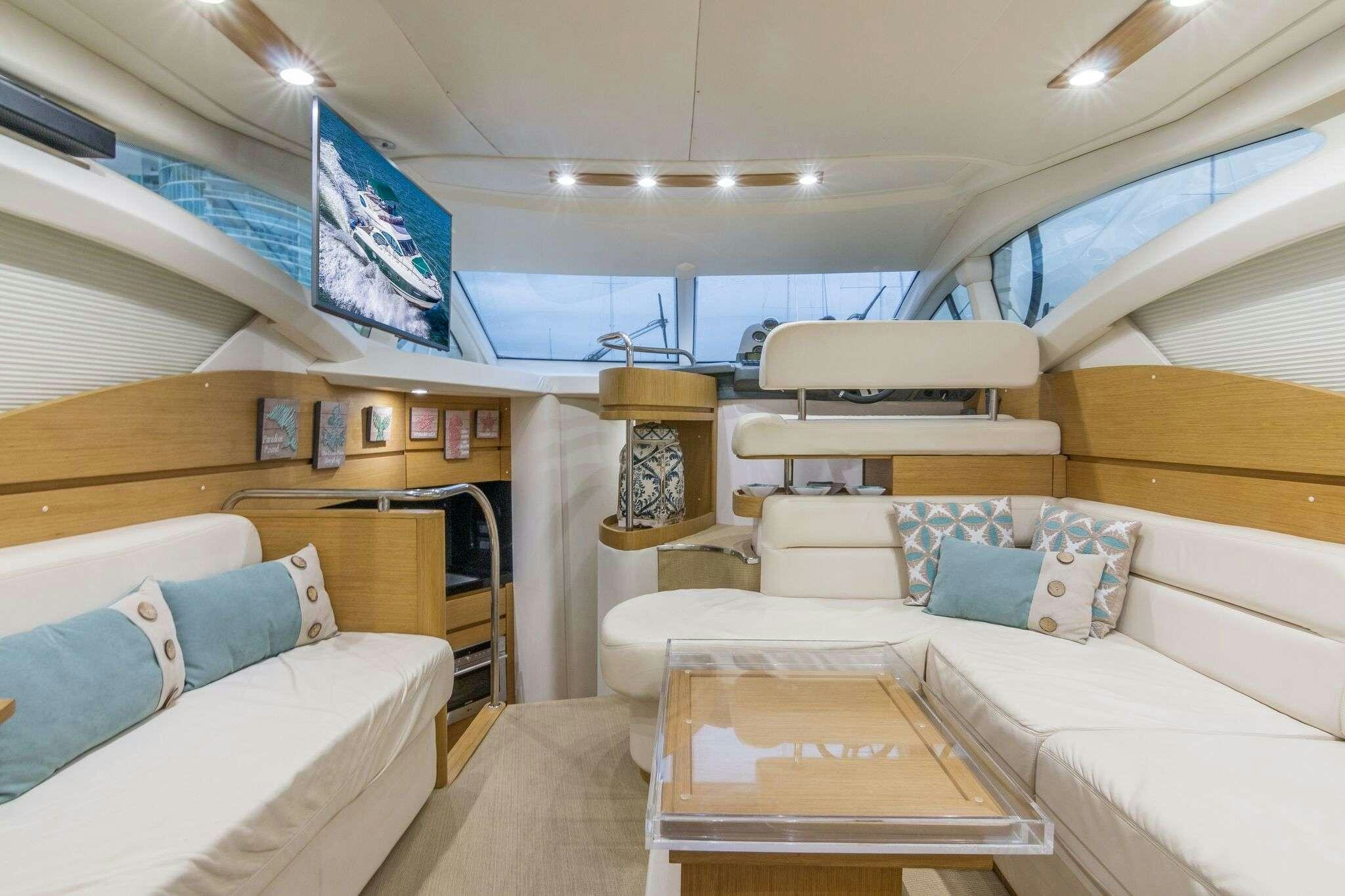 a room with a bed and a couch aboard TINA Yacht for Charter