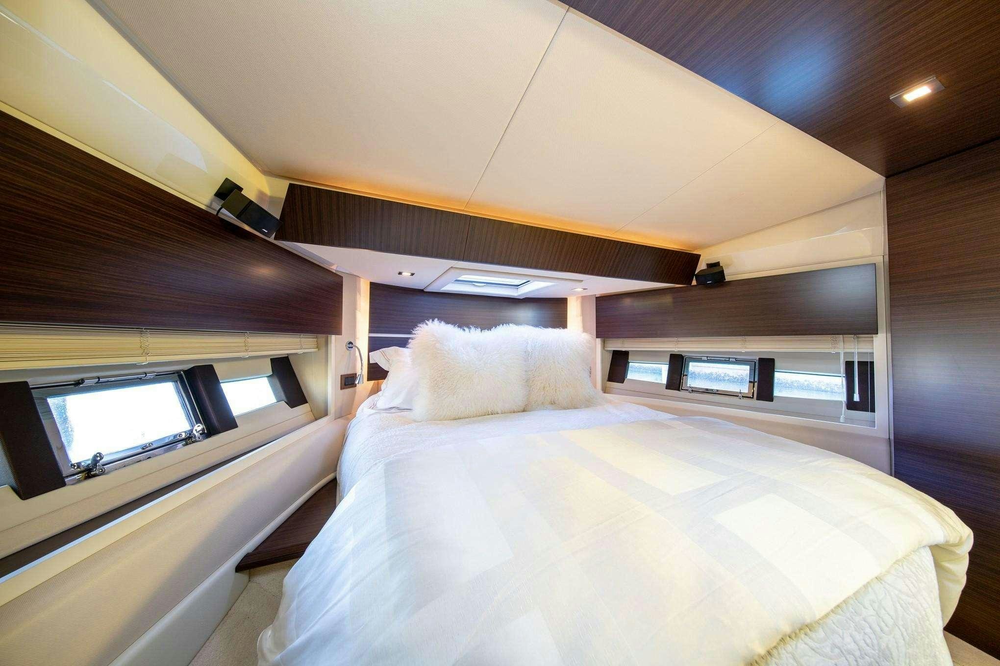 a bed with a white sheet aboard TINA Yacht for Charter