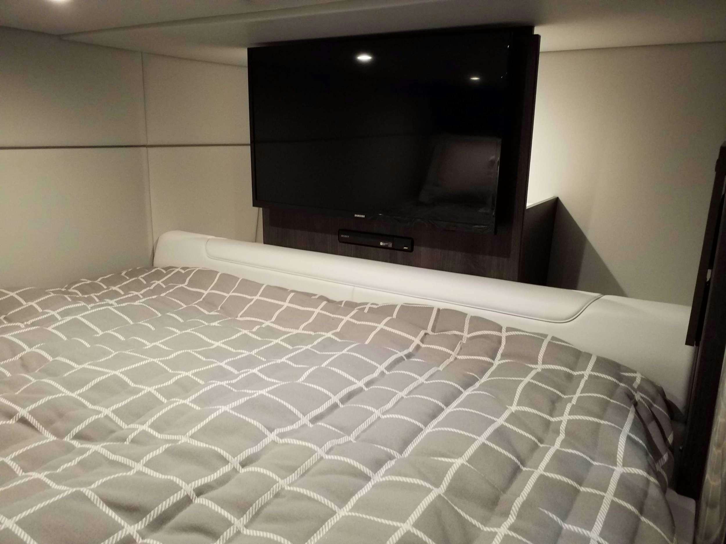 a bed with a television on top aboard Life Is Good Yacht for Charter