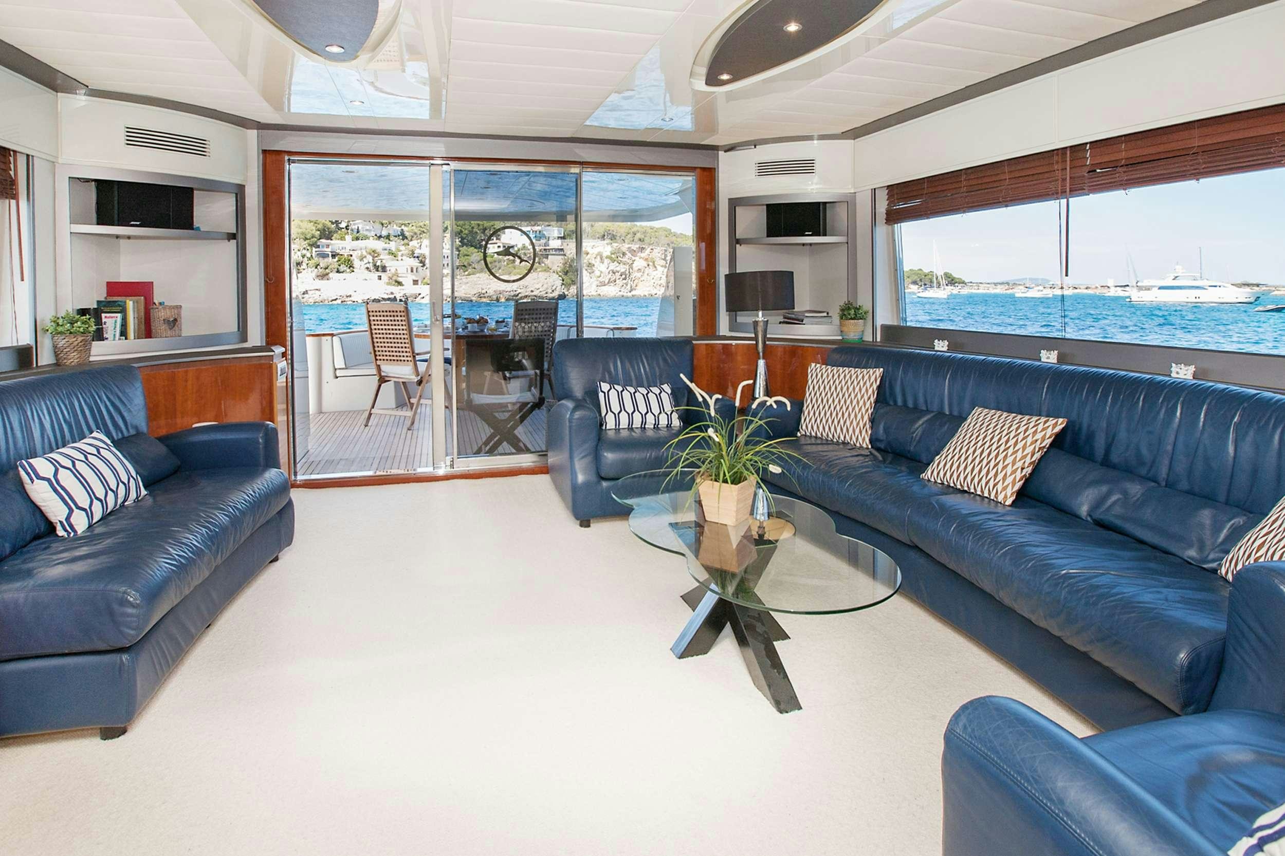 a living room with blue couches aboard WHITE FANG Yacht for Charter