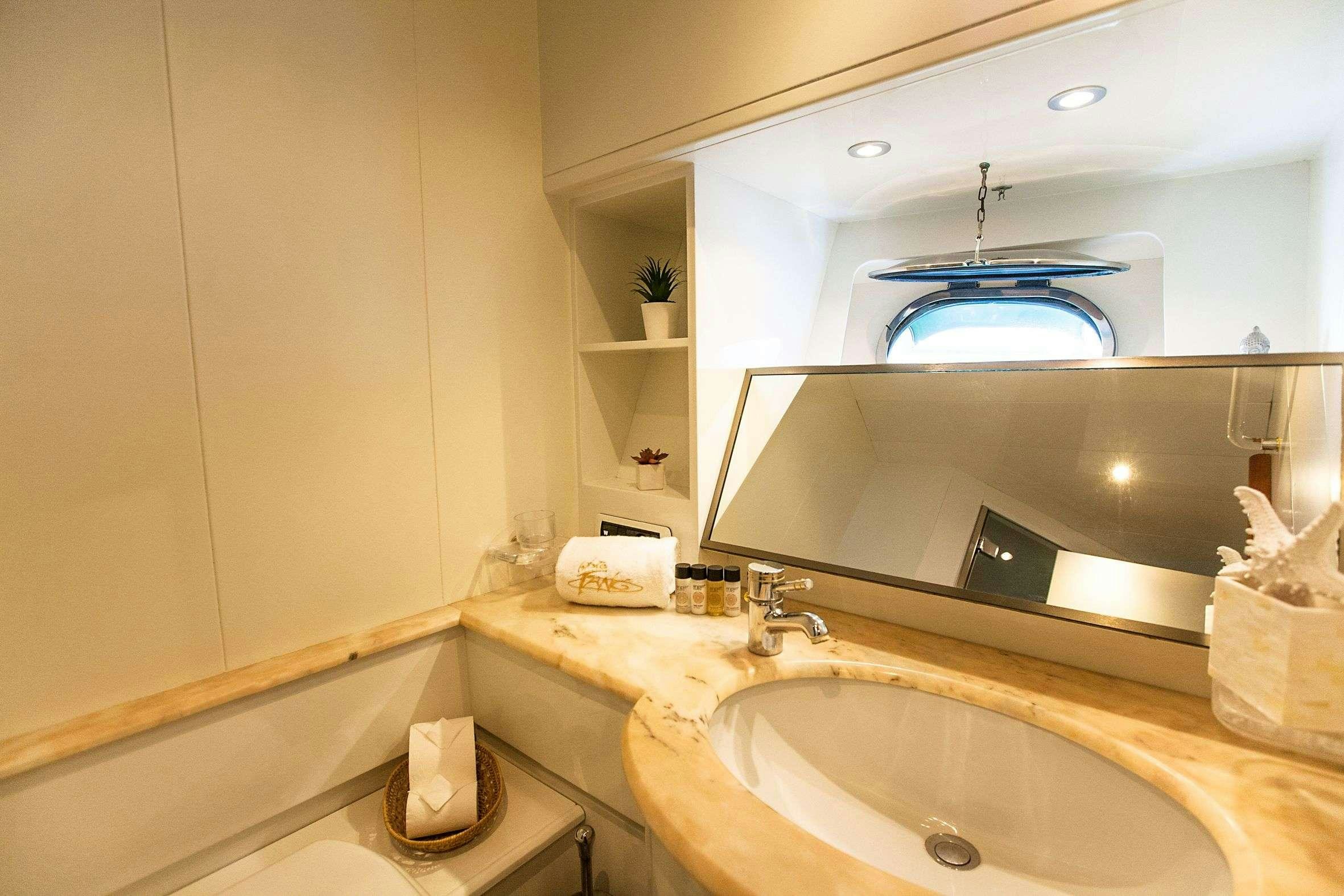 a bathroom with a large mirror aboard WHITE FANG Yacht for Charter