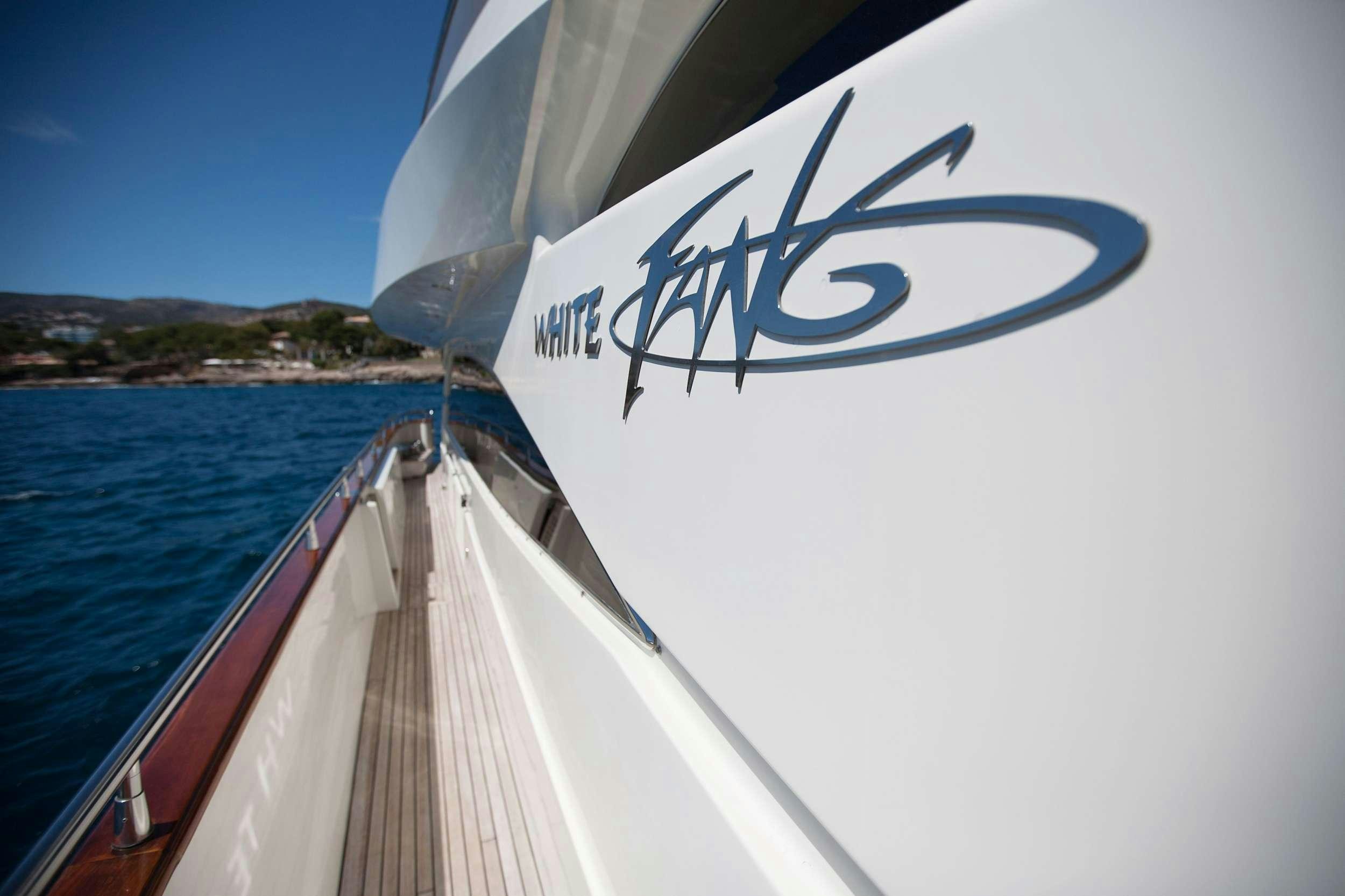 a boat with a sign on the front aboard WHITE FANG Yacht for Charter