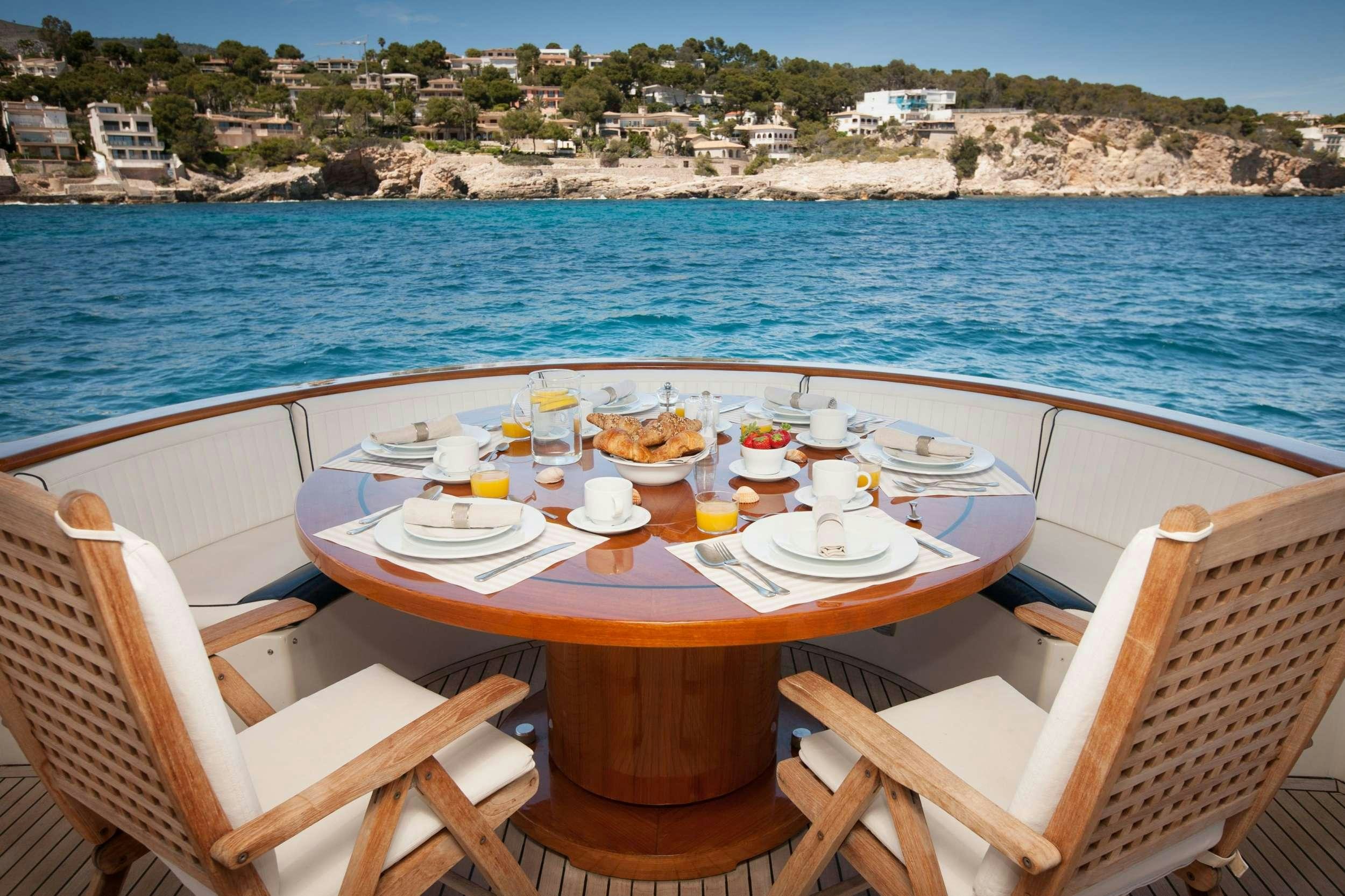 a table set for a meal on a beach aboard WHITE FANG Yacht for Charter