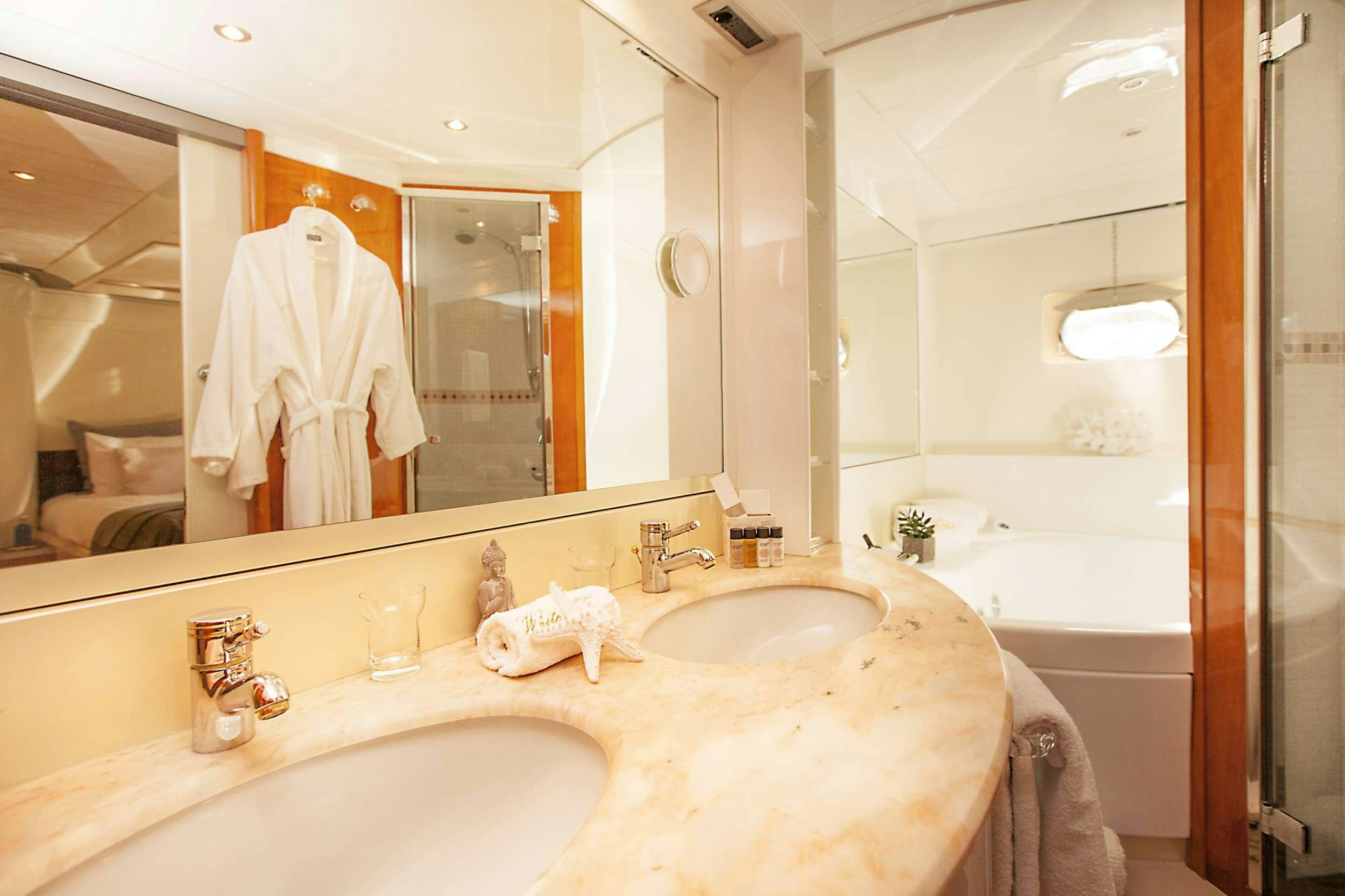 a bathroom with a large mirror aboard WHITE FANG Yacht for Charter
